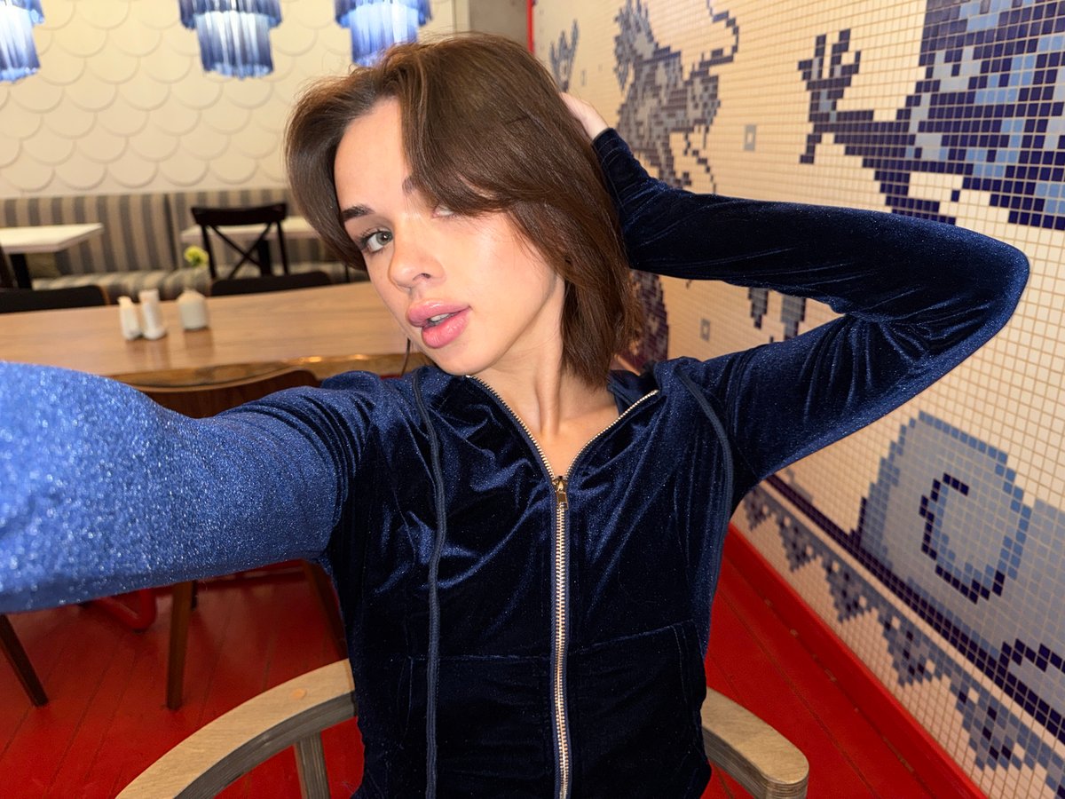 Woman documents cafe visit with selfies in Perm