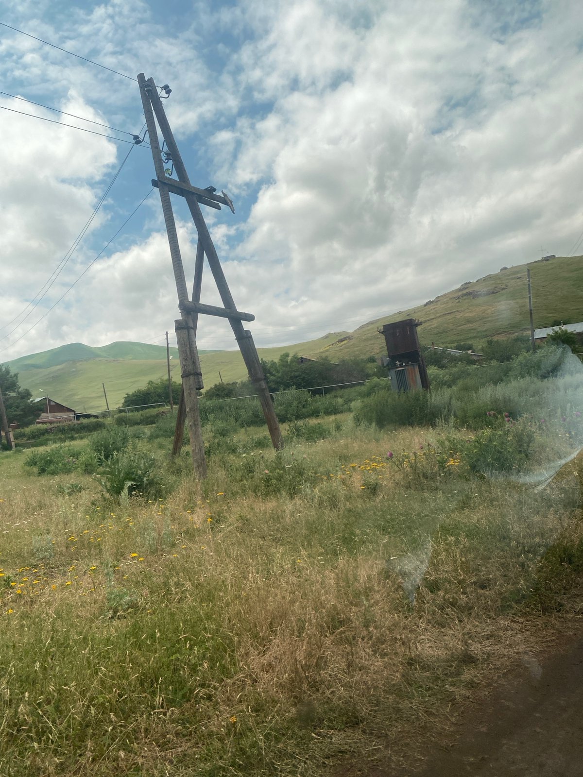 Morning drive through green hills, wildflowers, and a rural stone church
