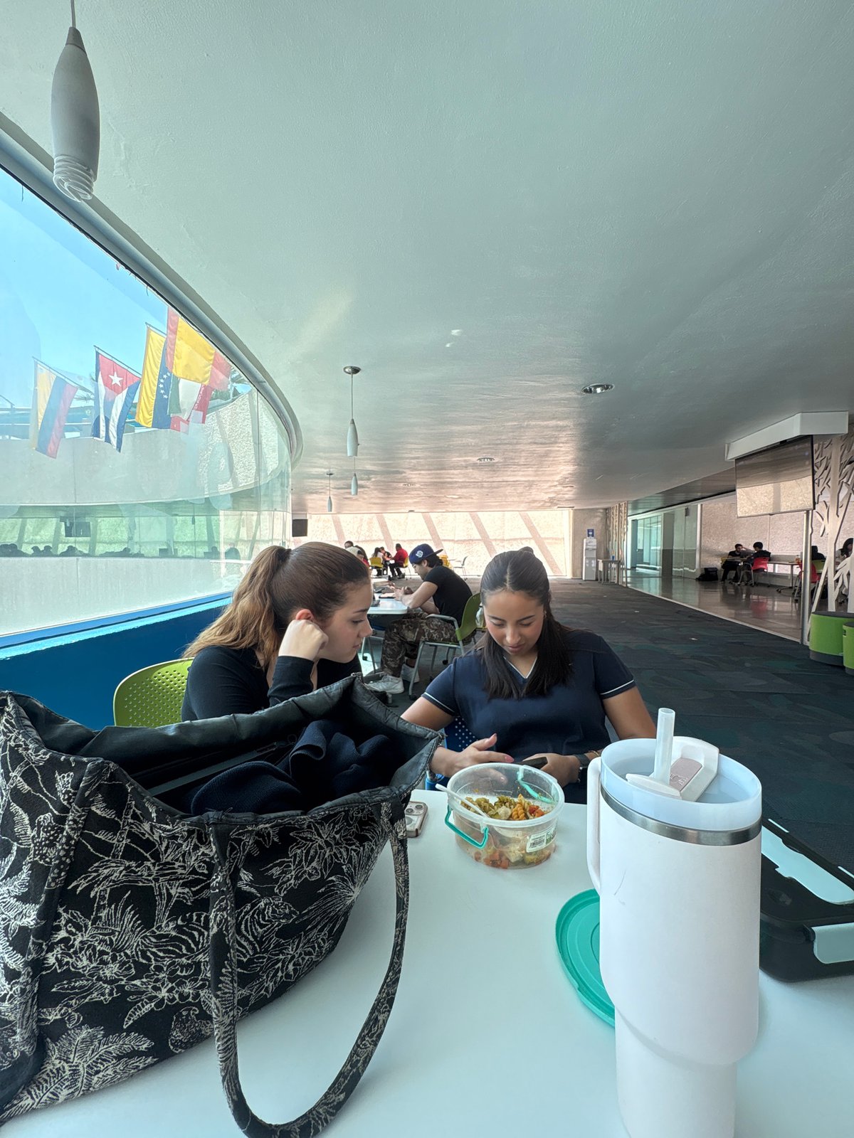 Two women dine at modern cafeteria in Puebla