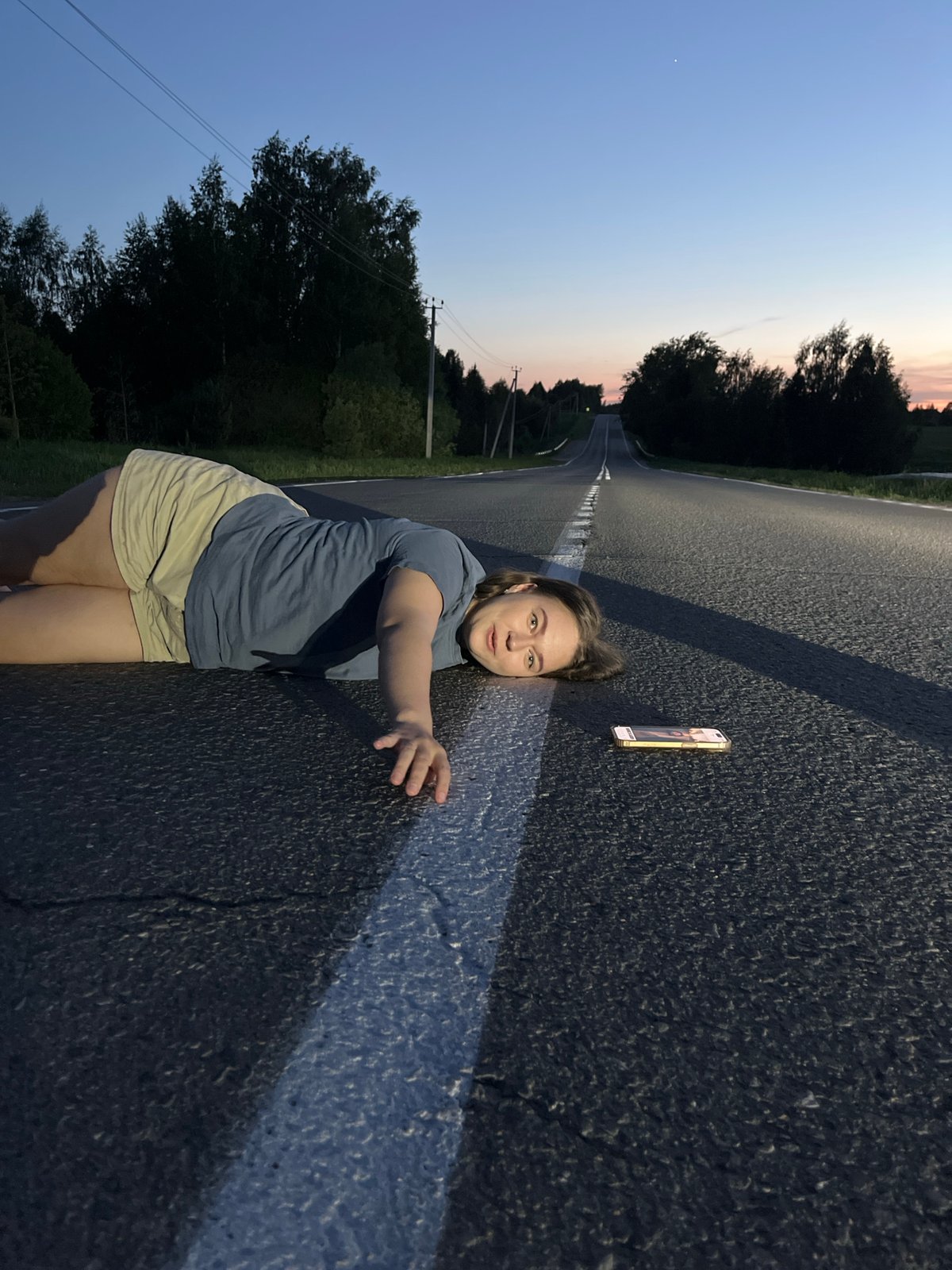 Women gather on road in Ольховка, Russia at dusk