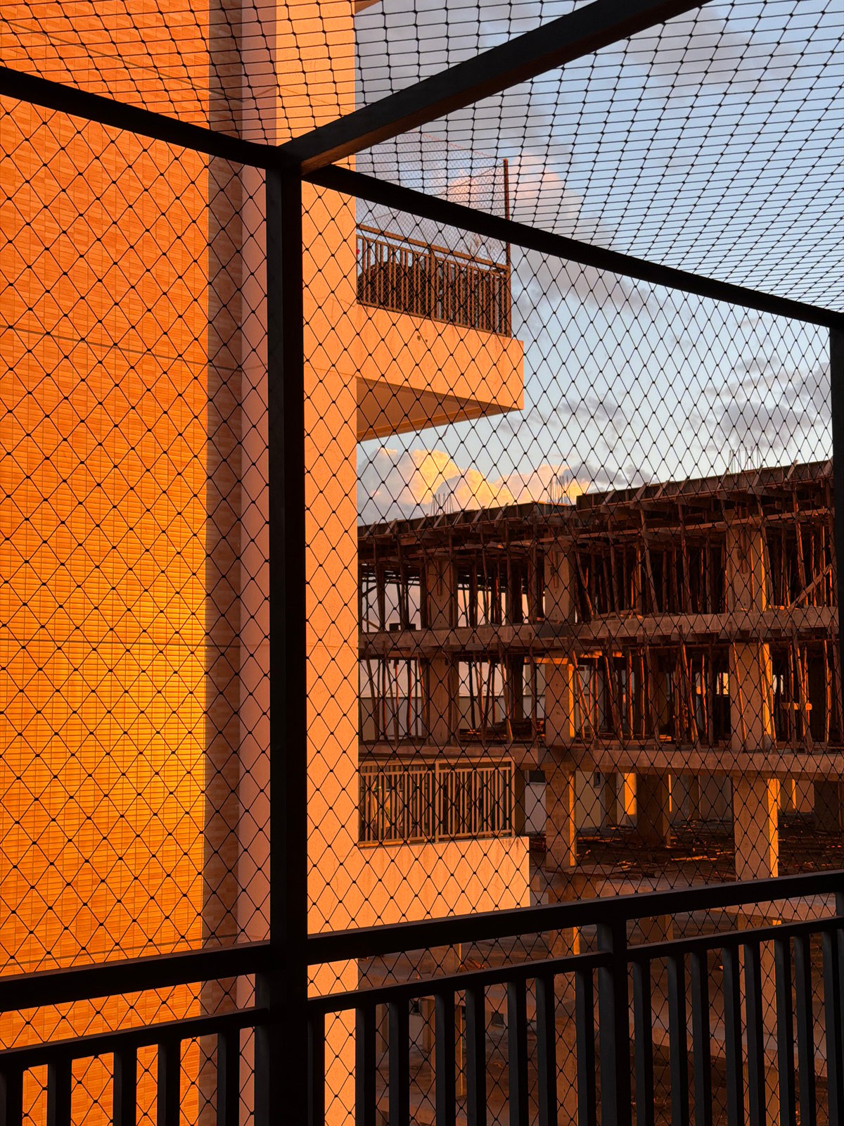 Wire fence frames modern architecture in evening Brasília