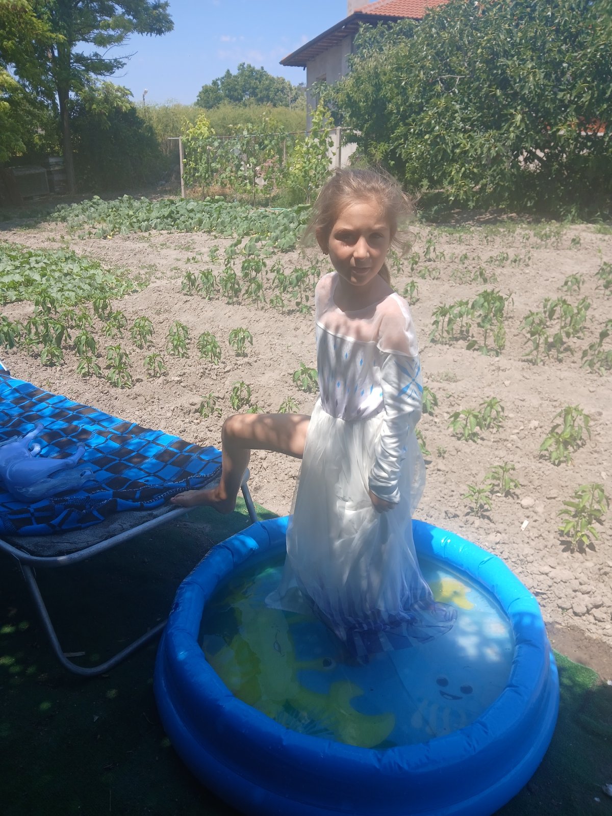 Backyard kiddie pool day in a Bulgarian garden