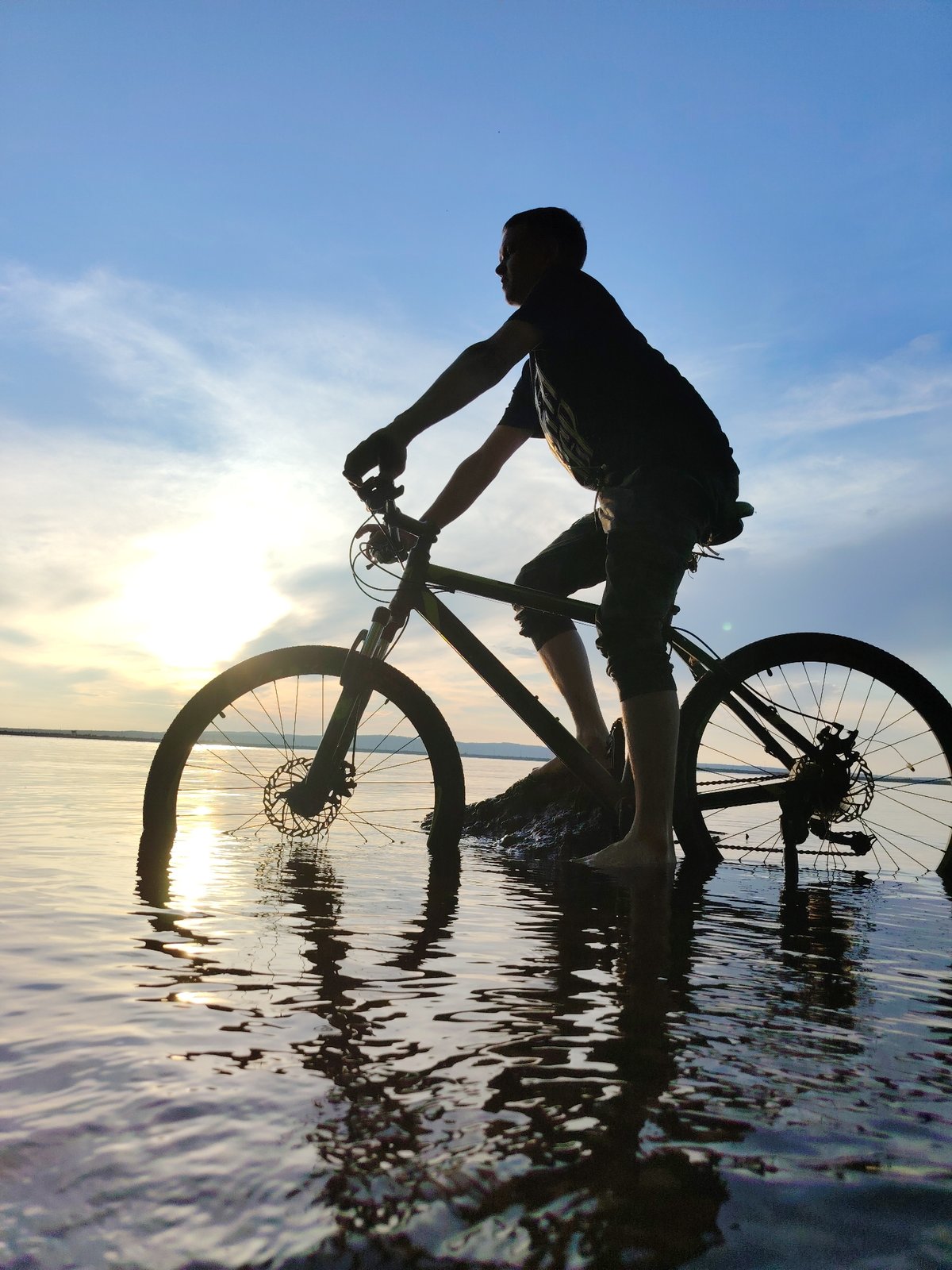 Creative sunset photography session with bicycle in Kama River