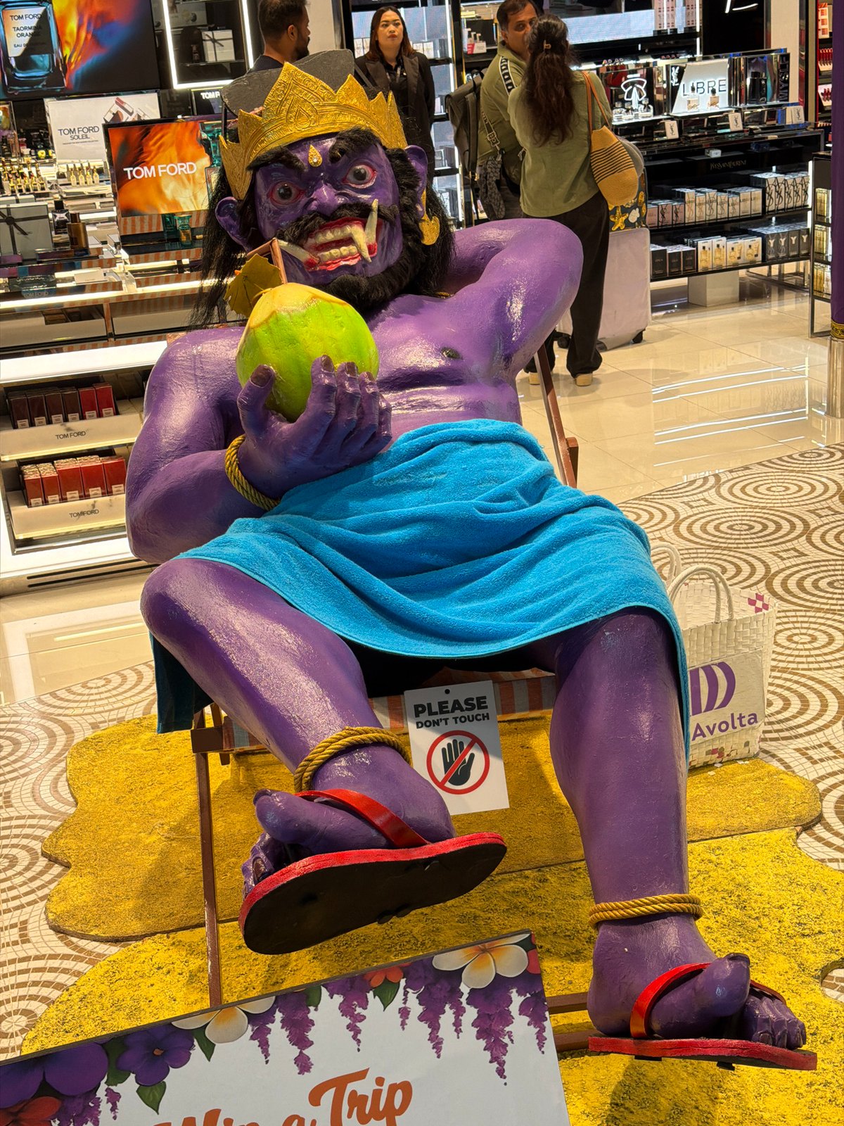 Demon statue chills on a beach chair in Kuta