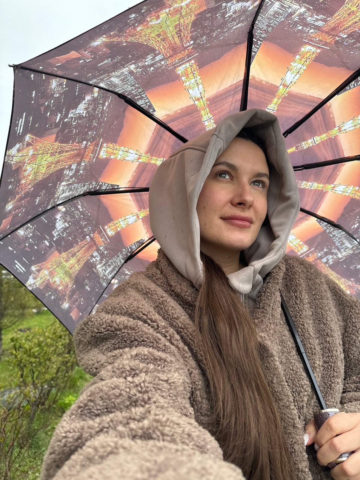 Woman with child walks in rain in Odintsovo