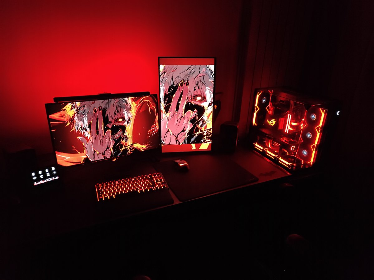 Gaming setup displays anime artwork across dual monitors
