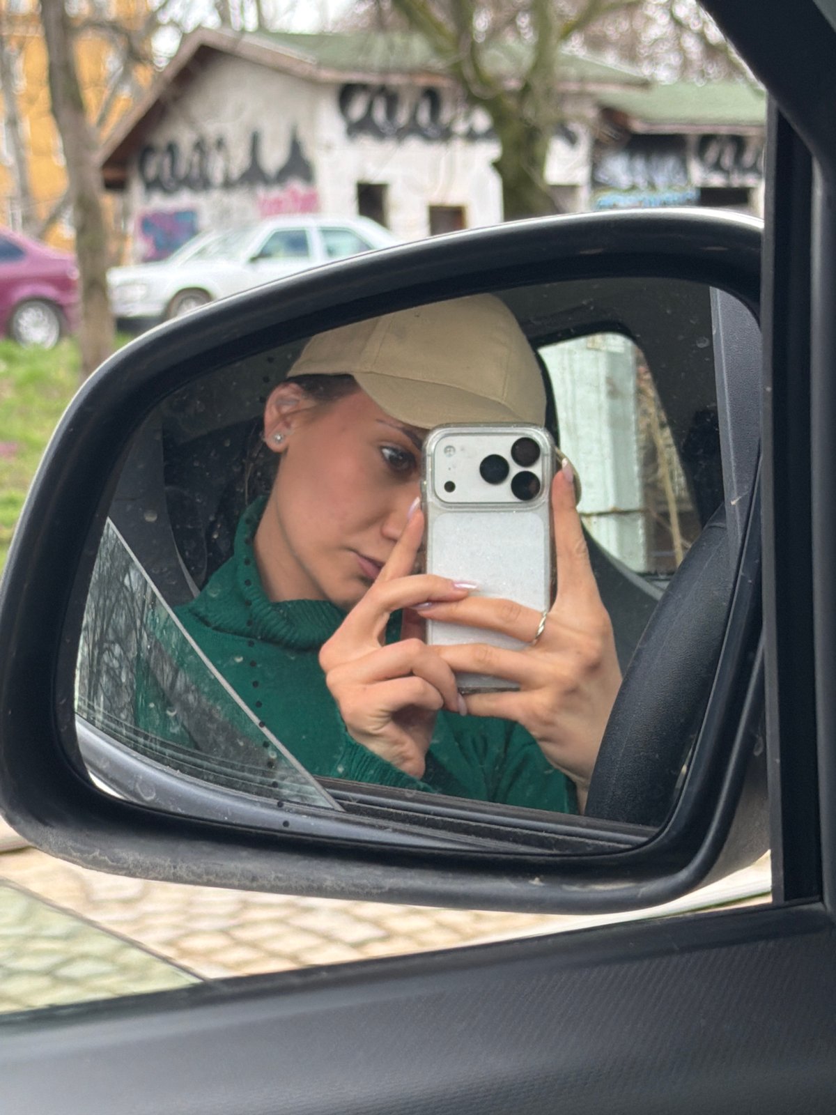 Woman takes mirror selfie in car in Sofia