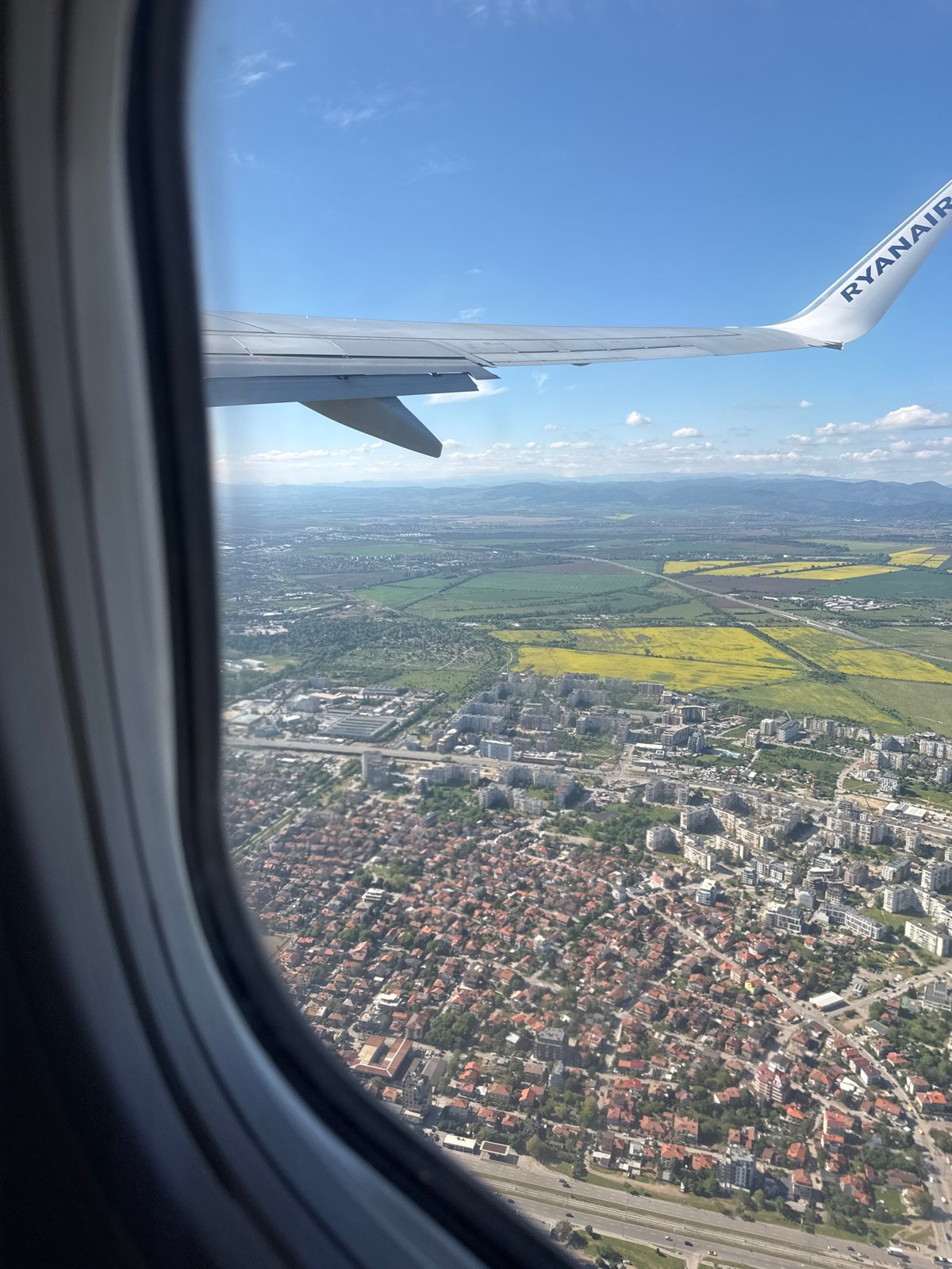 Sofia moments: airplane window view and driver's peace sign