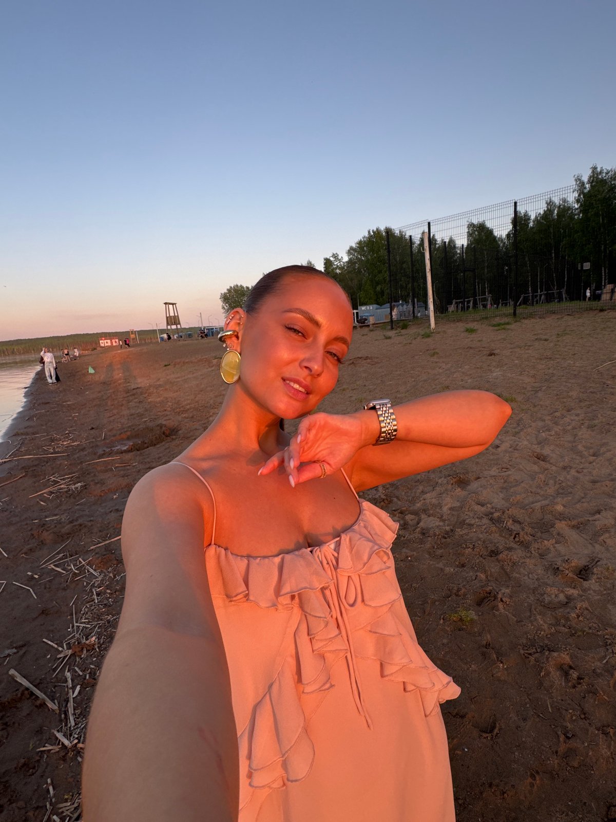 Woman takes outdoor selfie in pink dress, Chaikovsky Russia