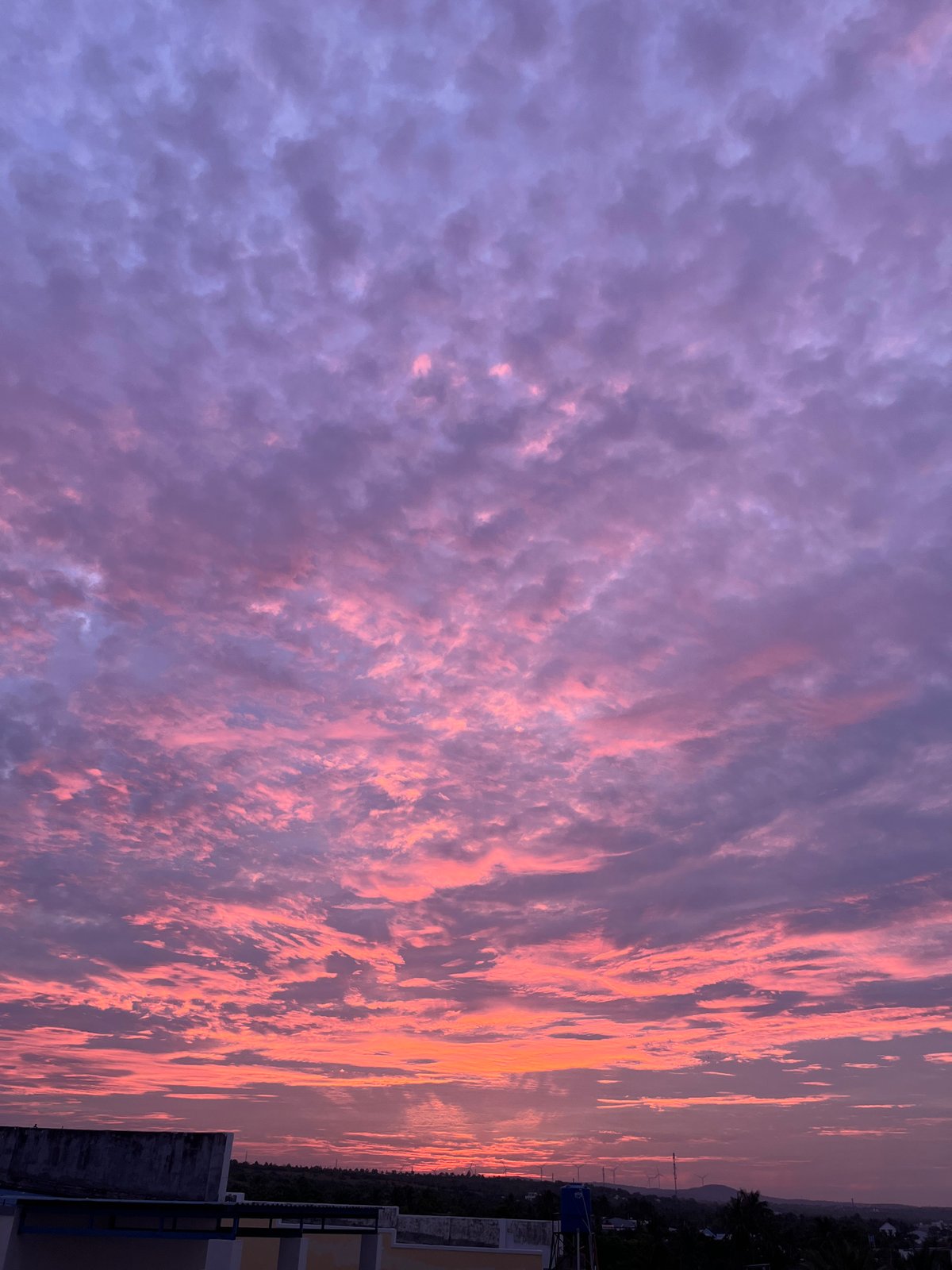 Vivid sunset sky over Mũi Né rooftops