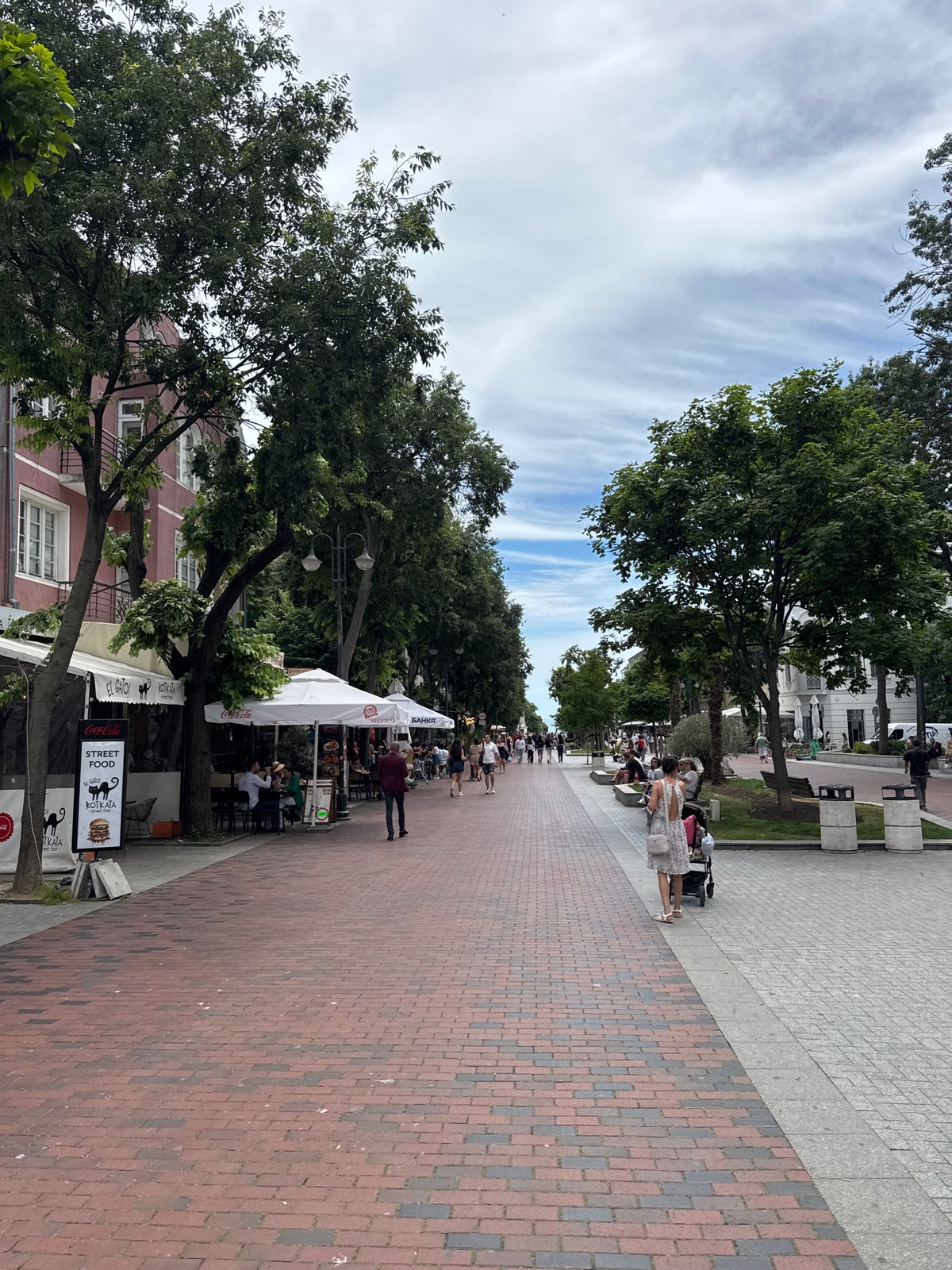 Morning café scene on Varna's pedestrian street, seagulls included