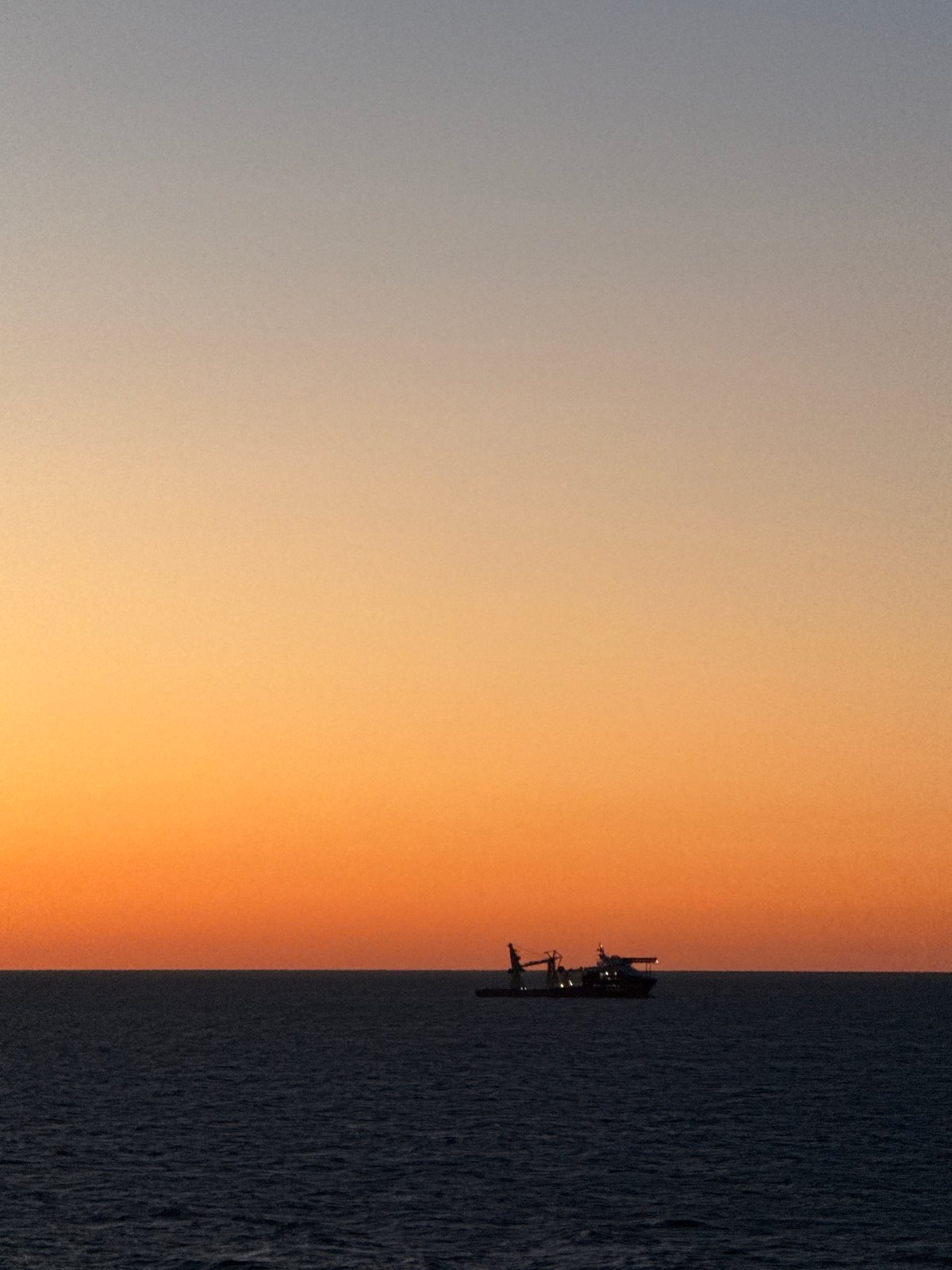 Gulf sunset documented with birds, oil rig visible