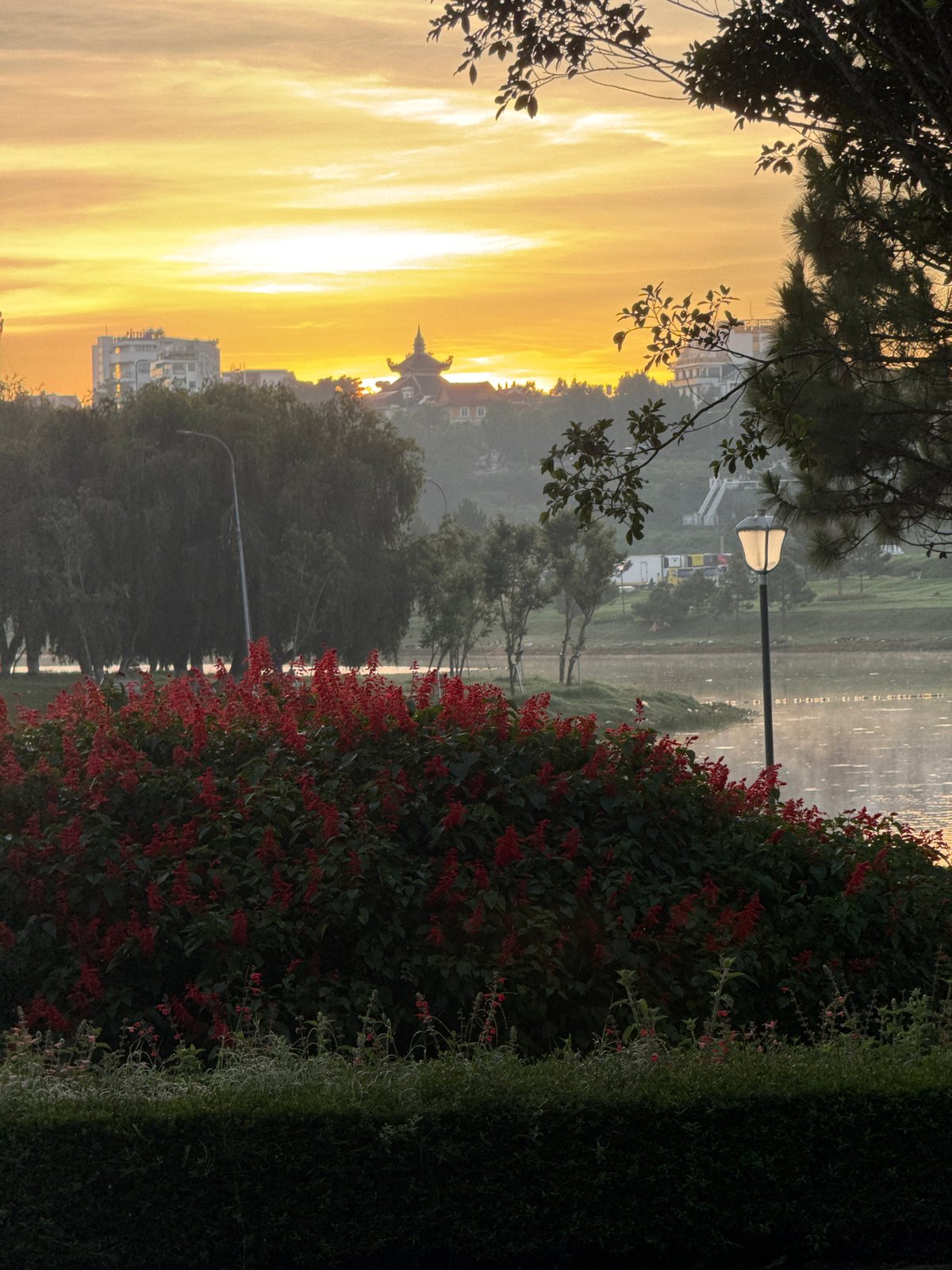 Cyclists and runners circle Xuan Huong Lake at dawn