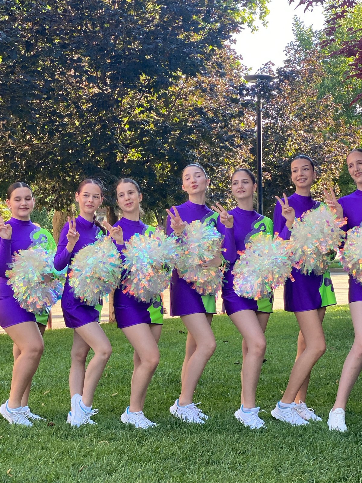 Cheerleading squad poses with pom-poms on Pleven lawn