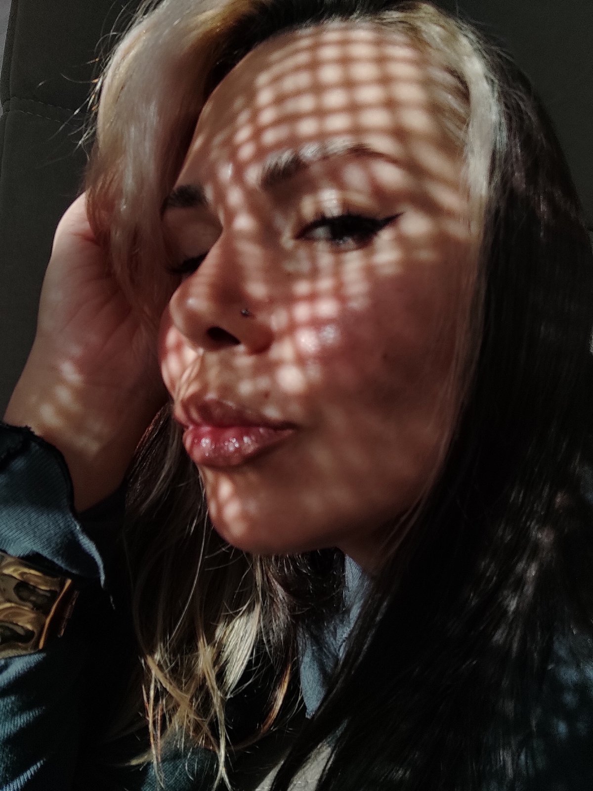 Woman displays artwork indoors in Chaikovsky, Russia