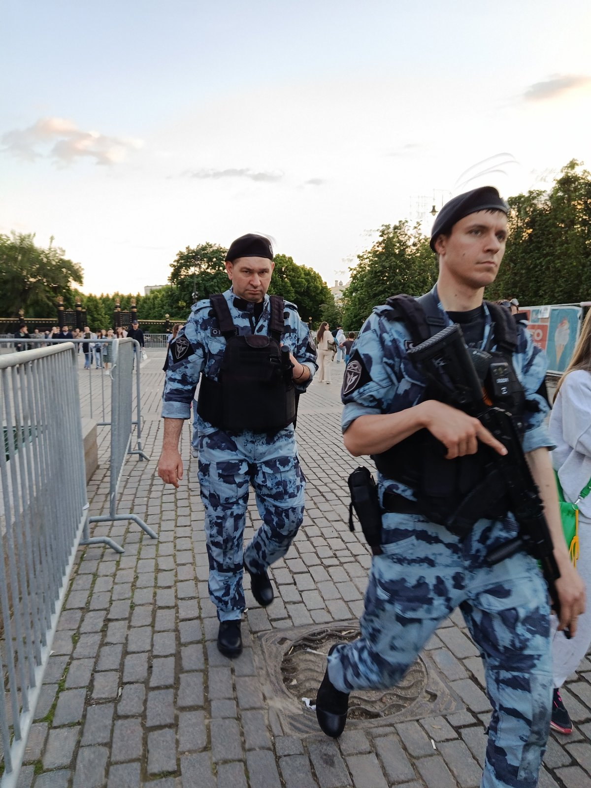 Urban scenes show military presence, civilian gatherings near historic building