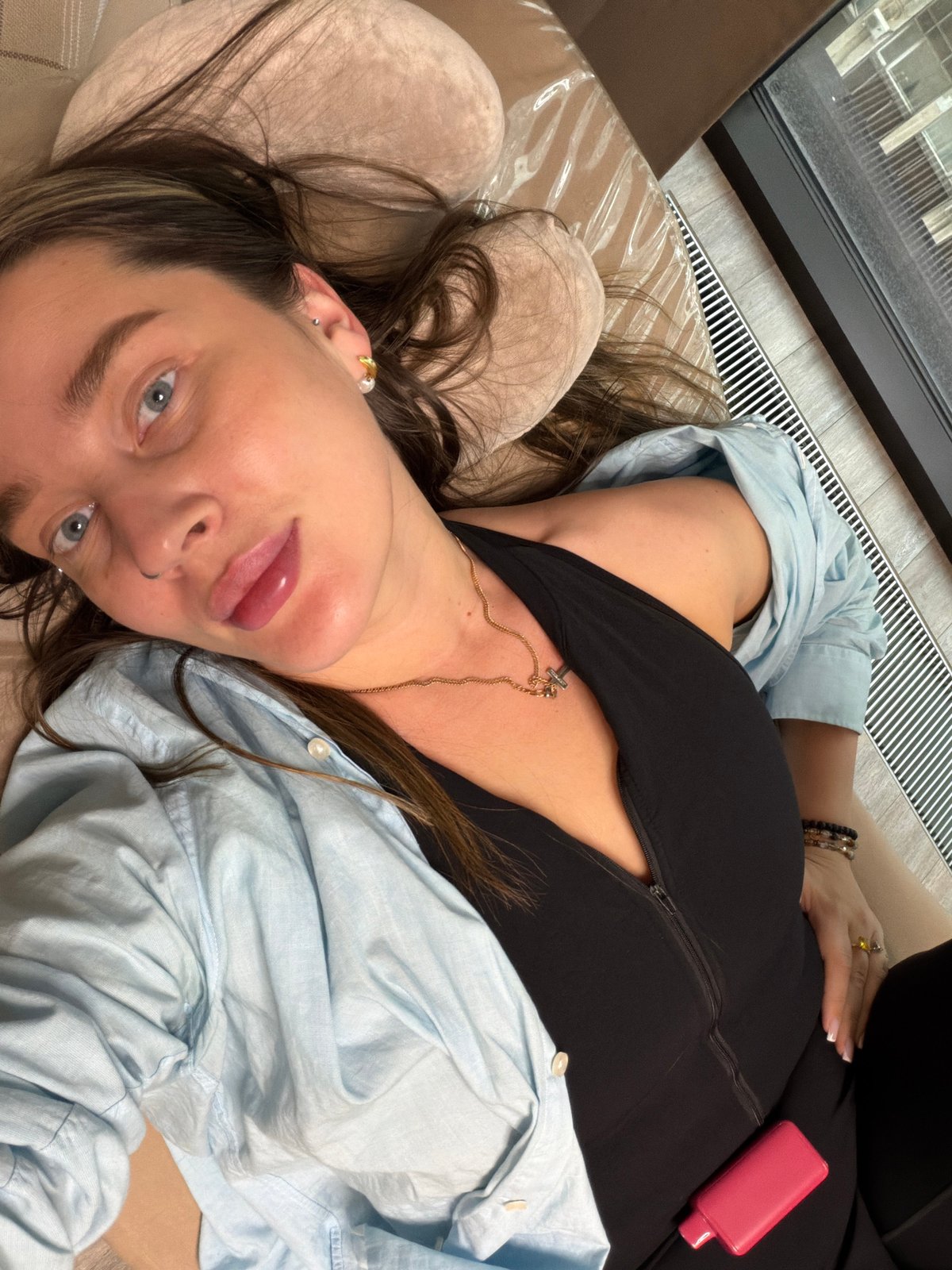 Woman rests on pillow in Moscow wearing cross necklace