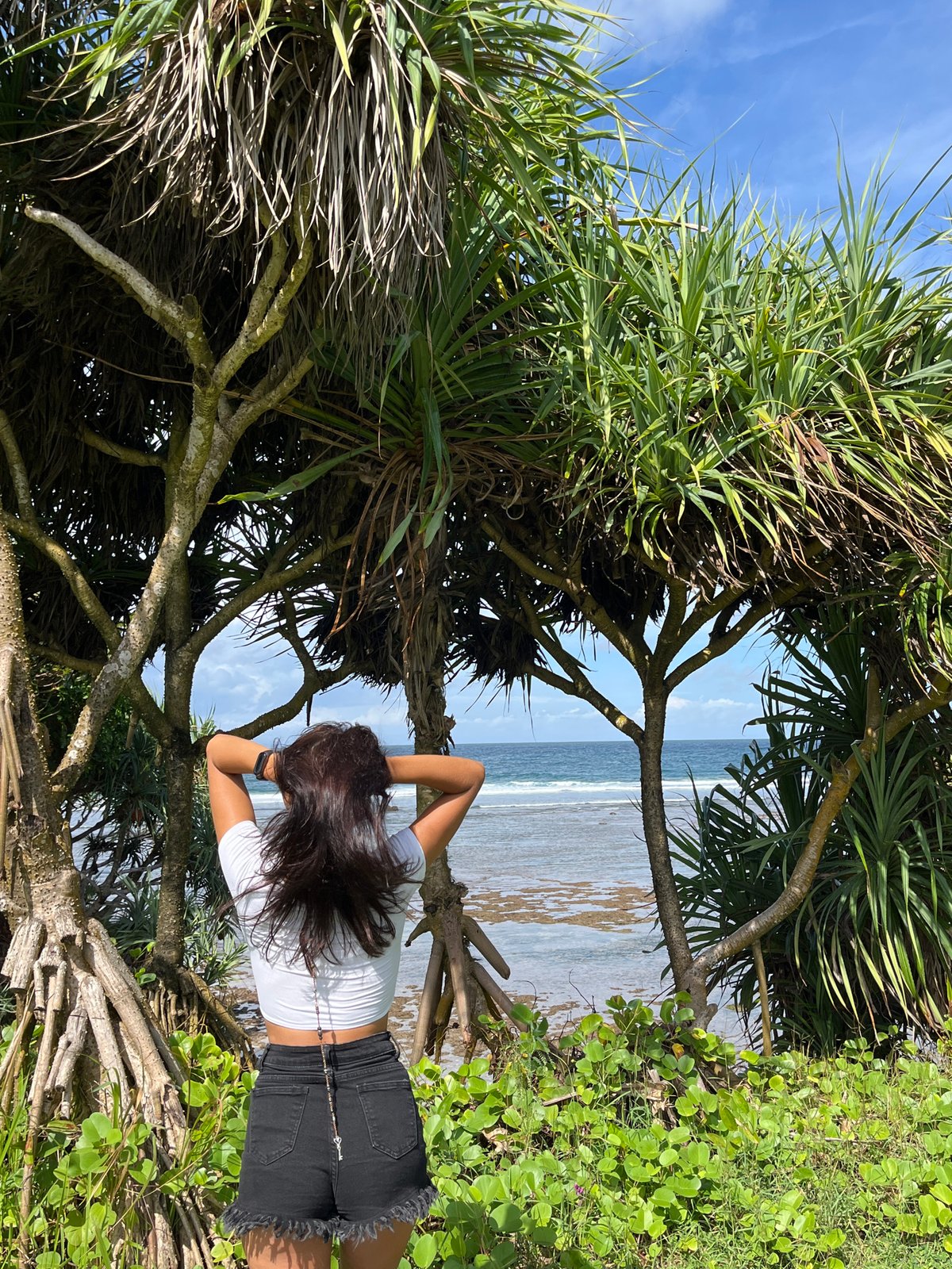 Woman poses for sunrise photo session at Kuta Selatan coast