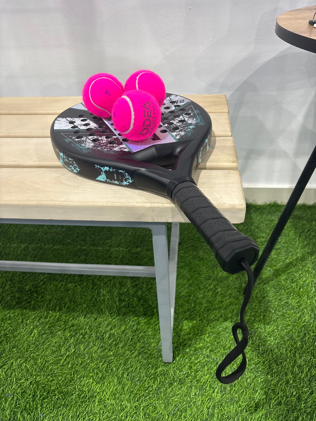 Padel gear laid out on a blue court in Chaikovsky