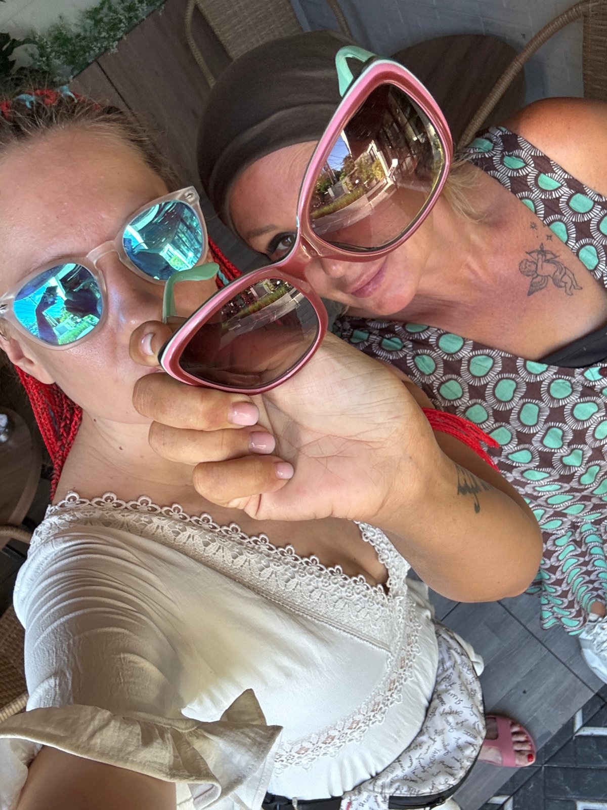 Two women relax at modern Kuta cafe