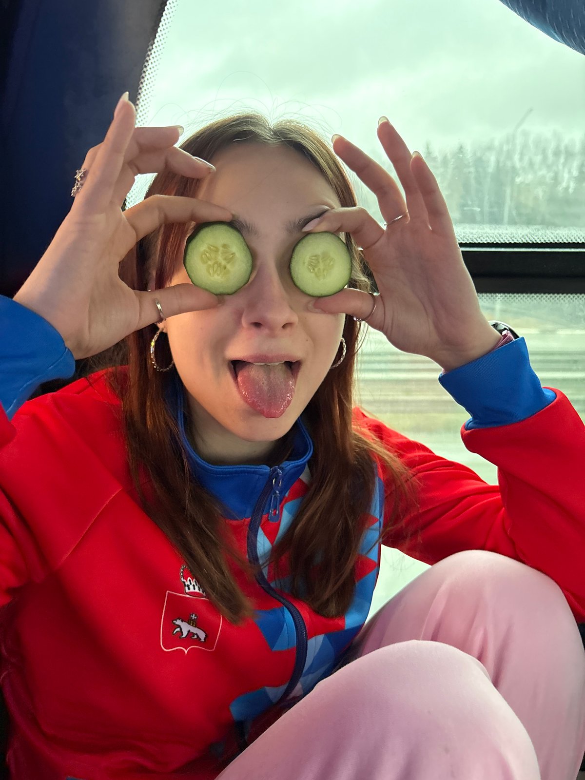 Woman poses with cucumber eye treatment in Yanychi, Russia