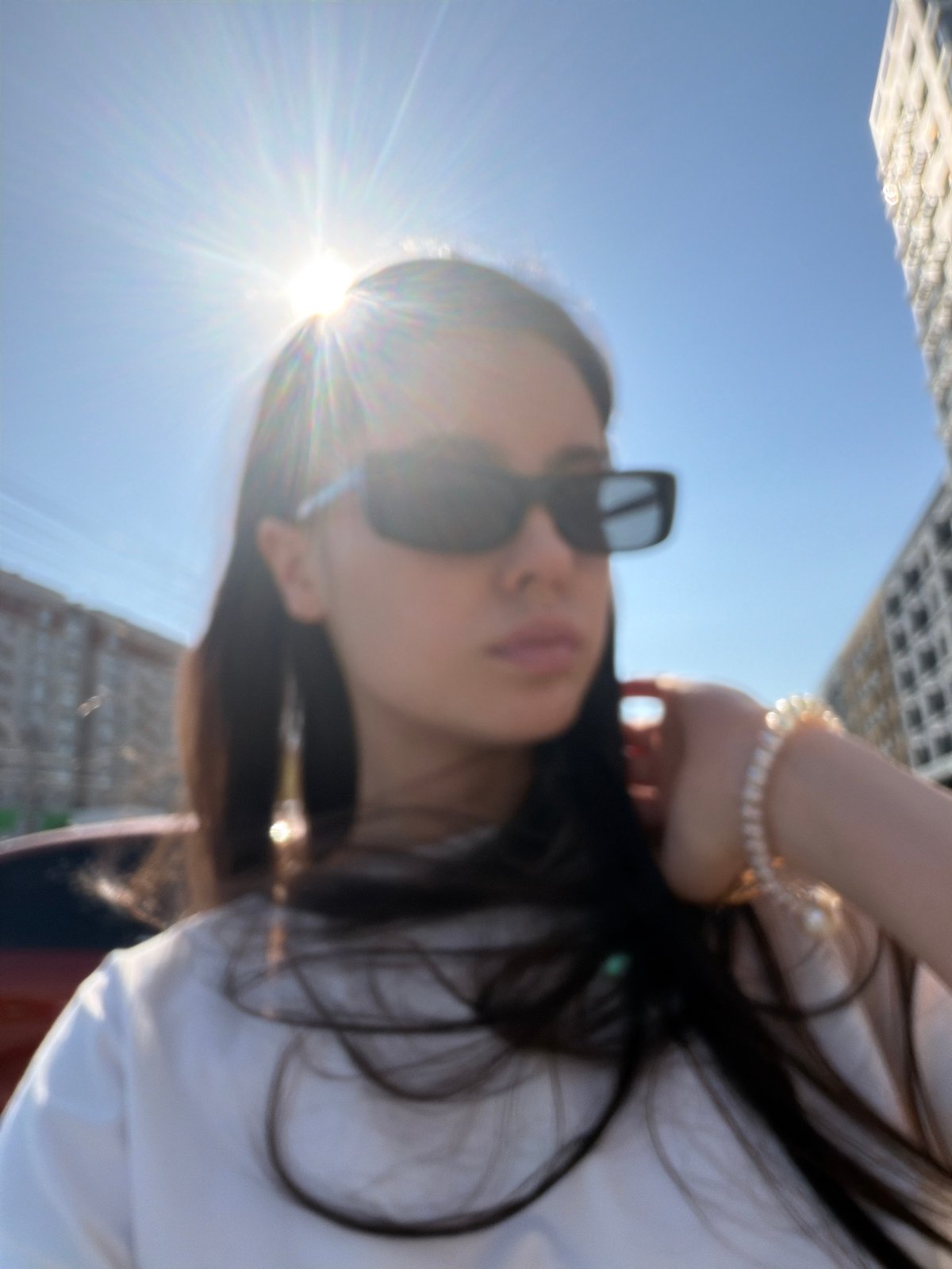 Woman takes selfies around Izhevsk during sunny spring morning
