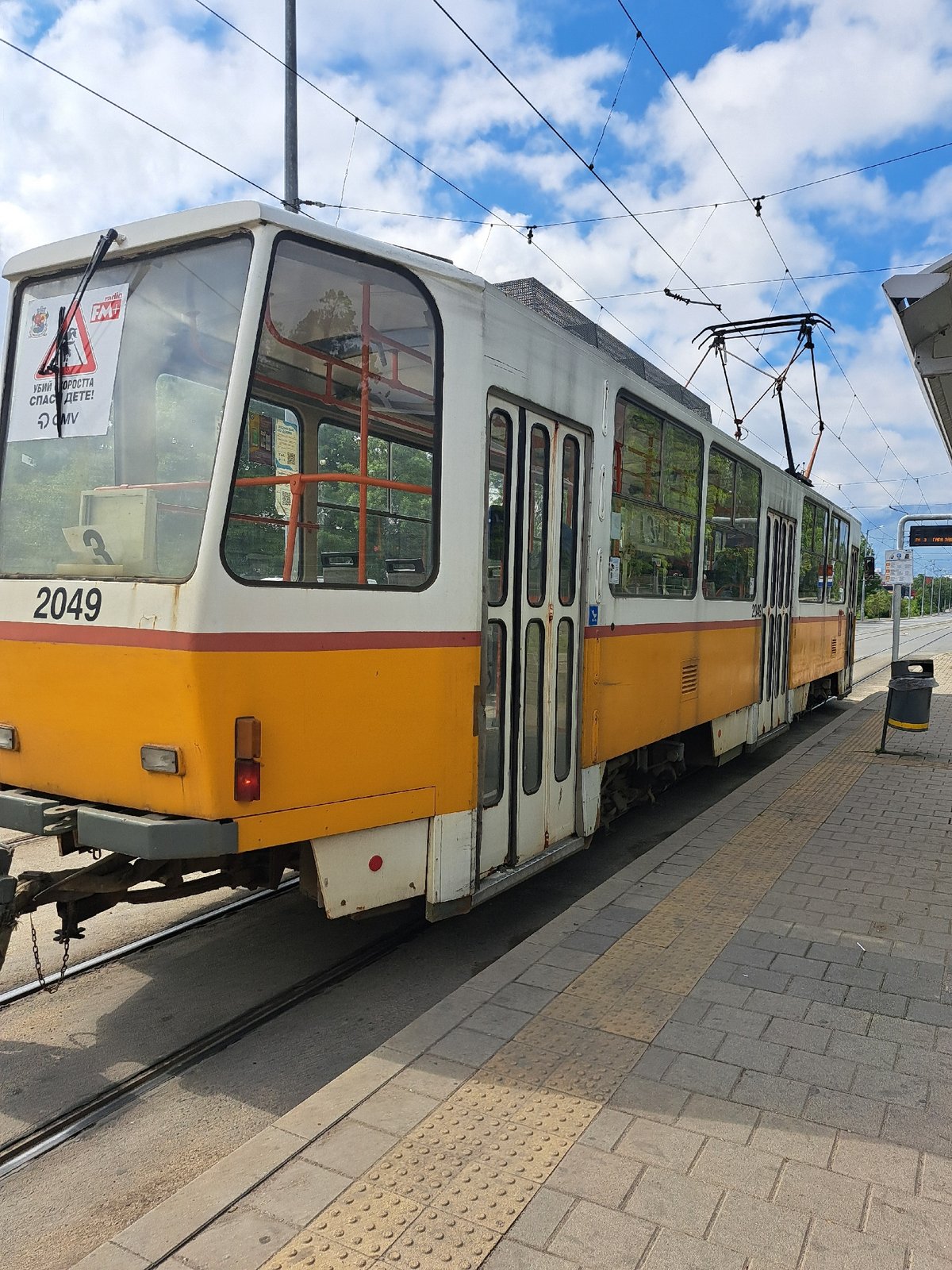 Tram 2049 stops at Sofia platform with tactile paving