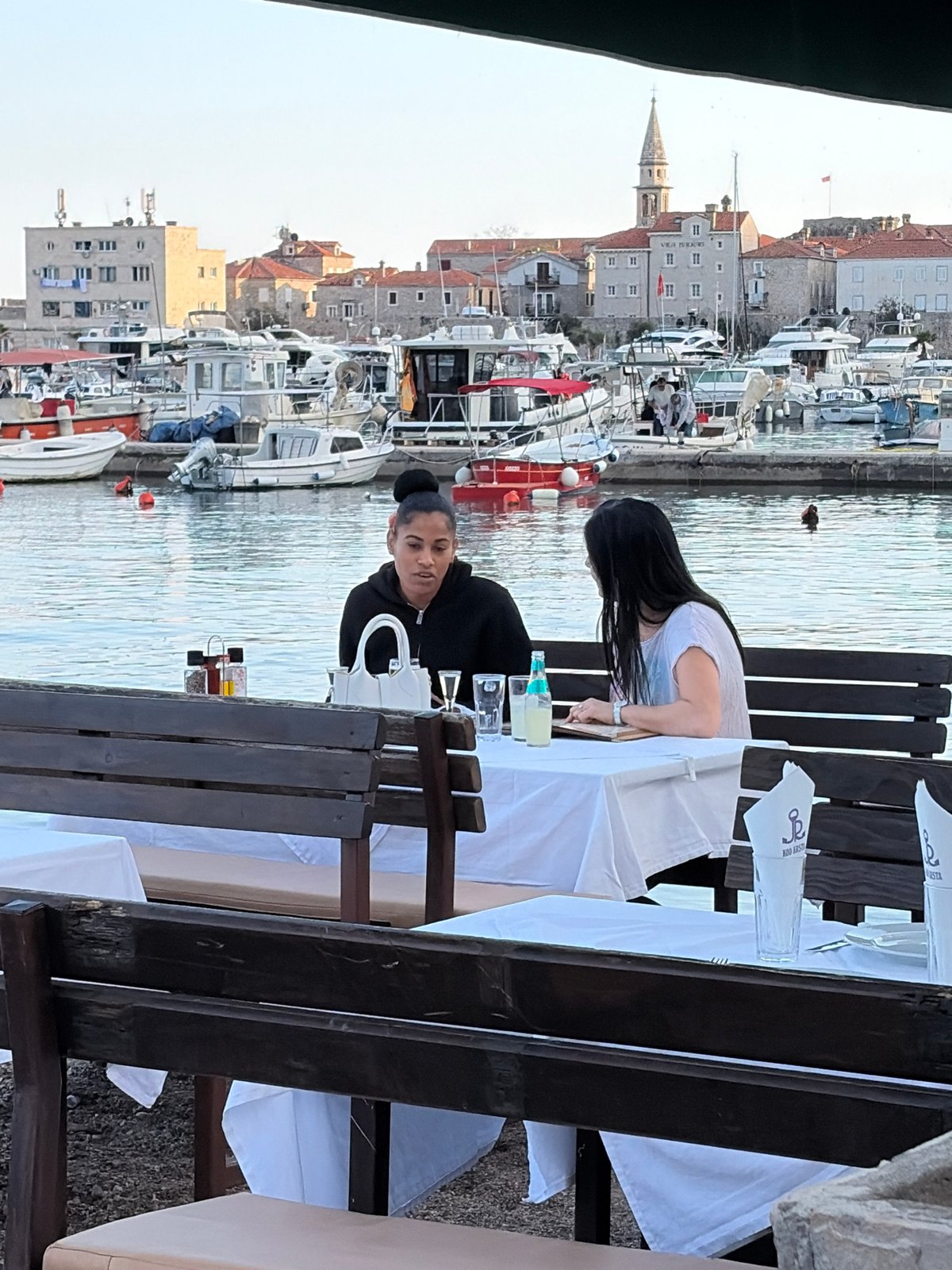 Afternoon life captured around Budva marina and waterfront cafes