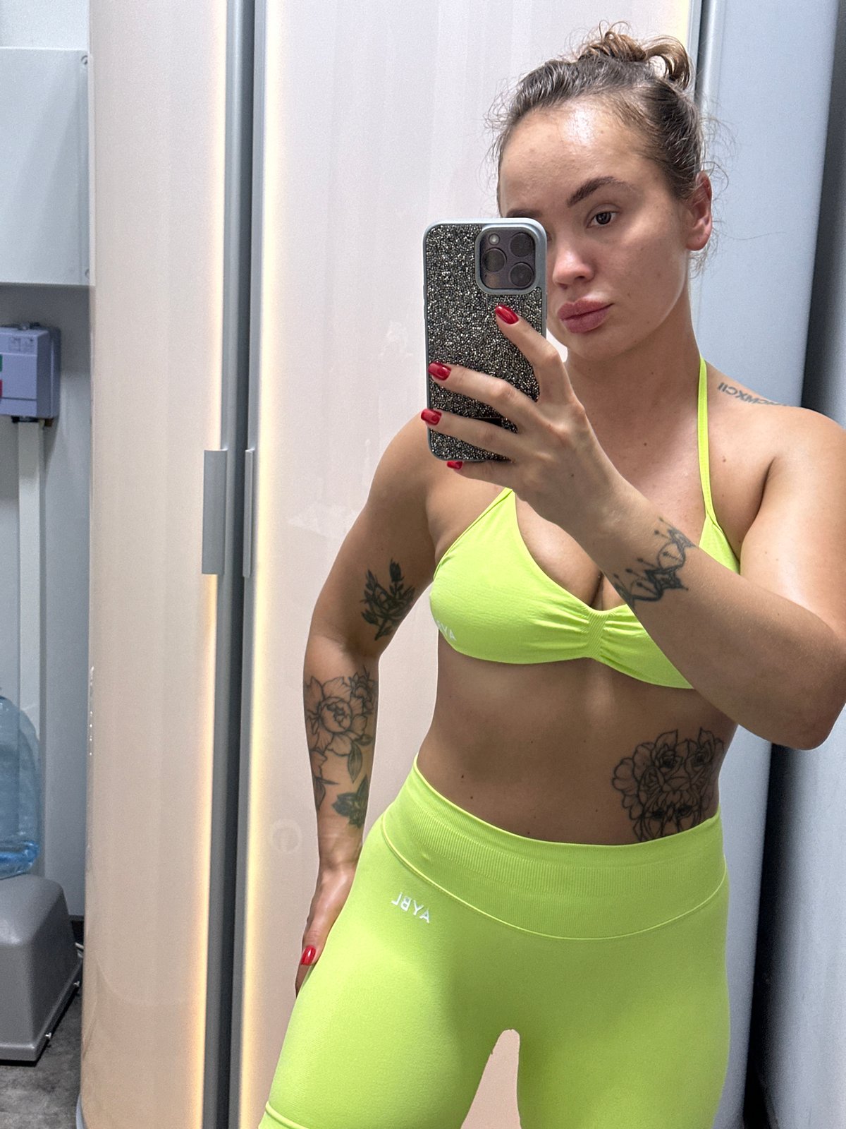 Mirror selfies in neon yellow across a gym and tanning salon
