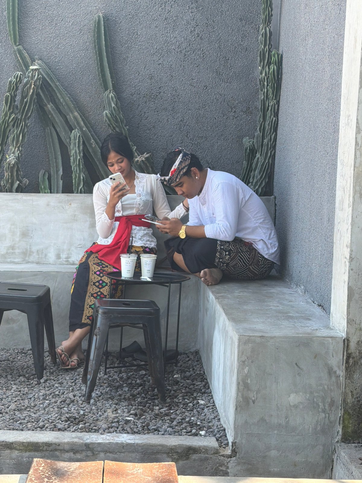 Woman uses phone at sunny Kuta beachside location