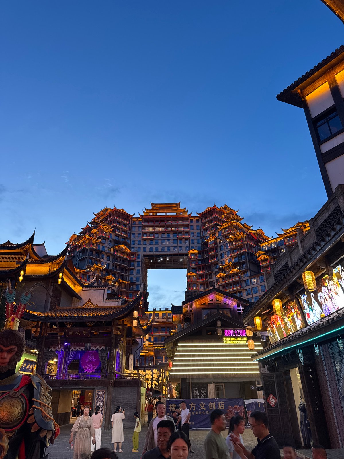 Zhangjiajie's lantern-lit streets at dusk, Monkey King theme throughout