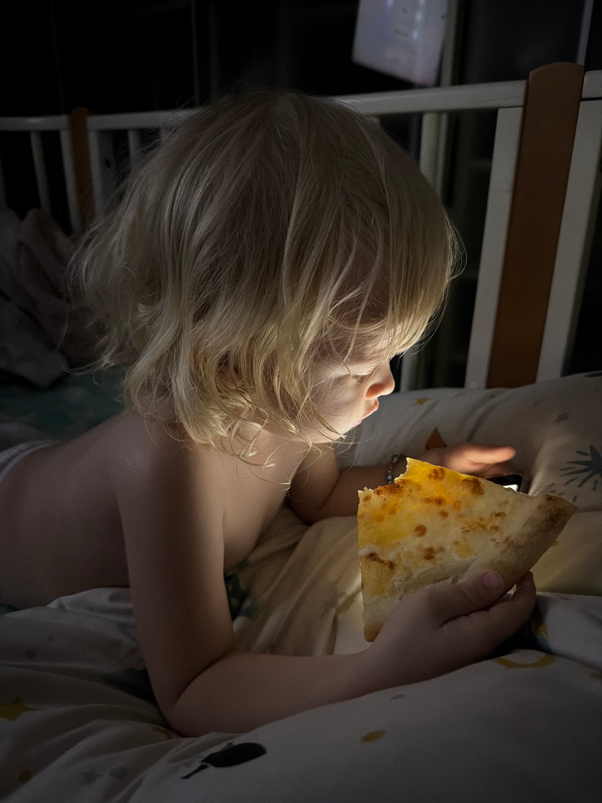 Toddler uses smartphone in crib during bedtime in Sochi
