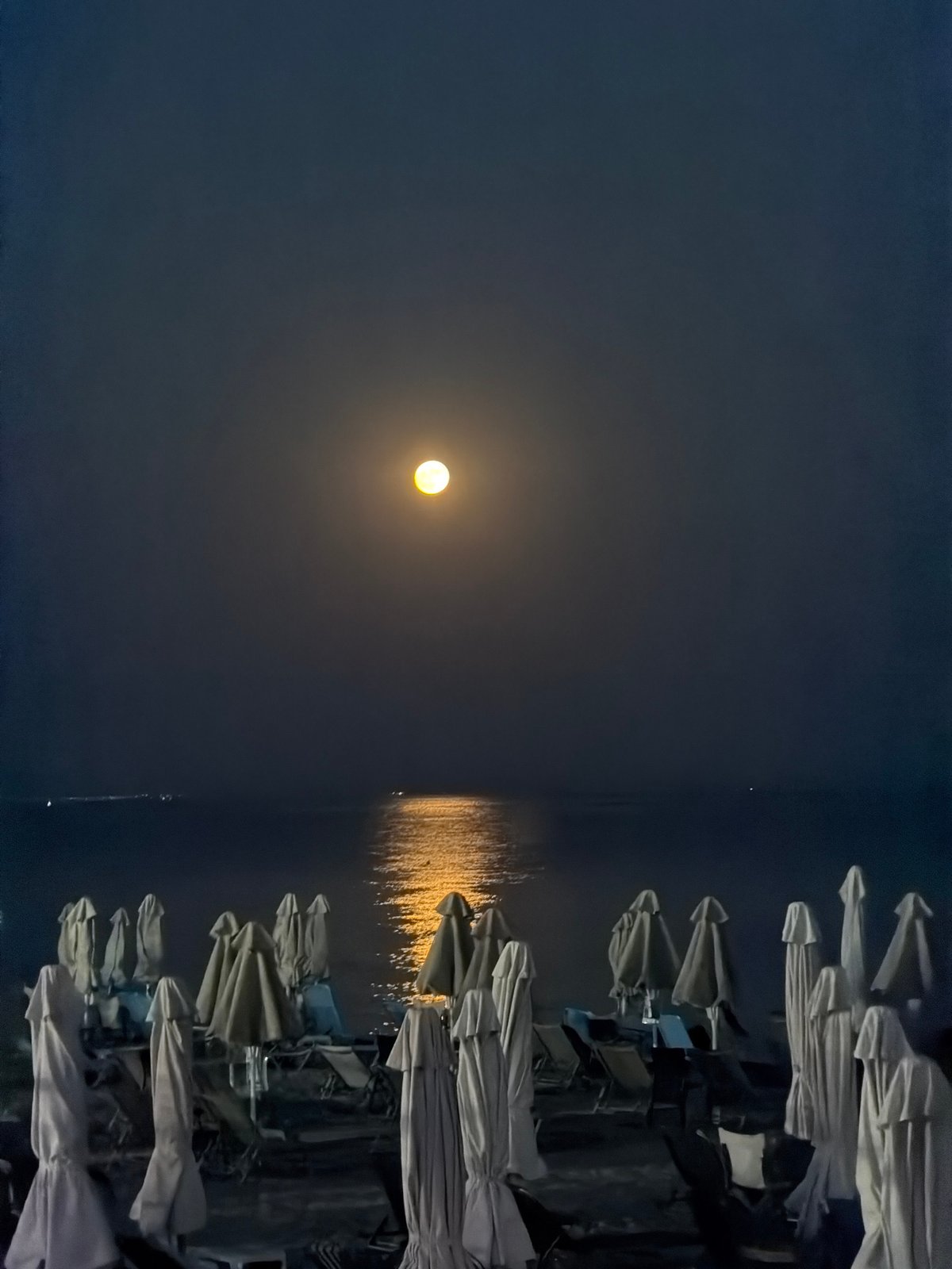 Full moon night over Nea Kallikratia's beachfront and waterfront dining