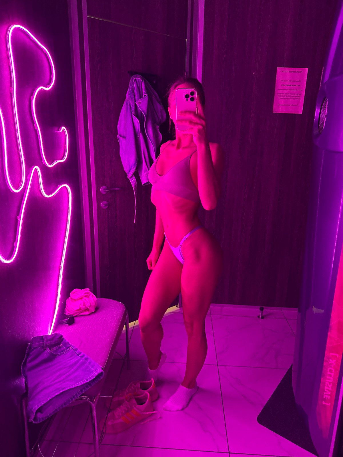 Woman takes selfies in Saint Petersburg tanning salon, retail locations