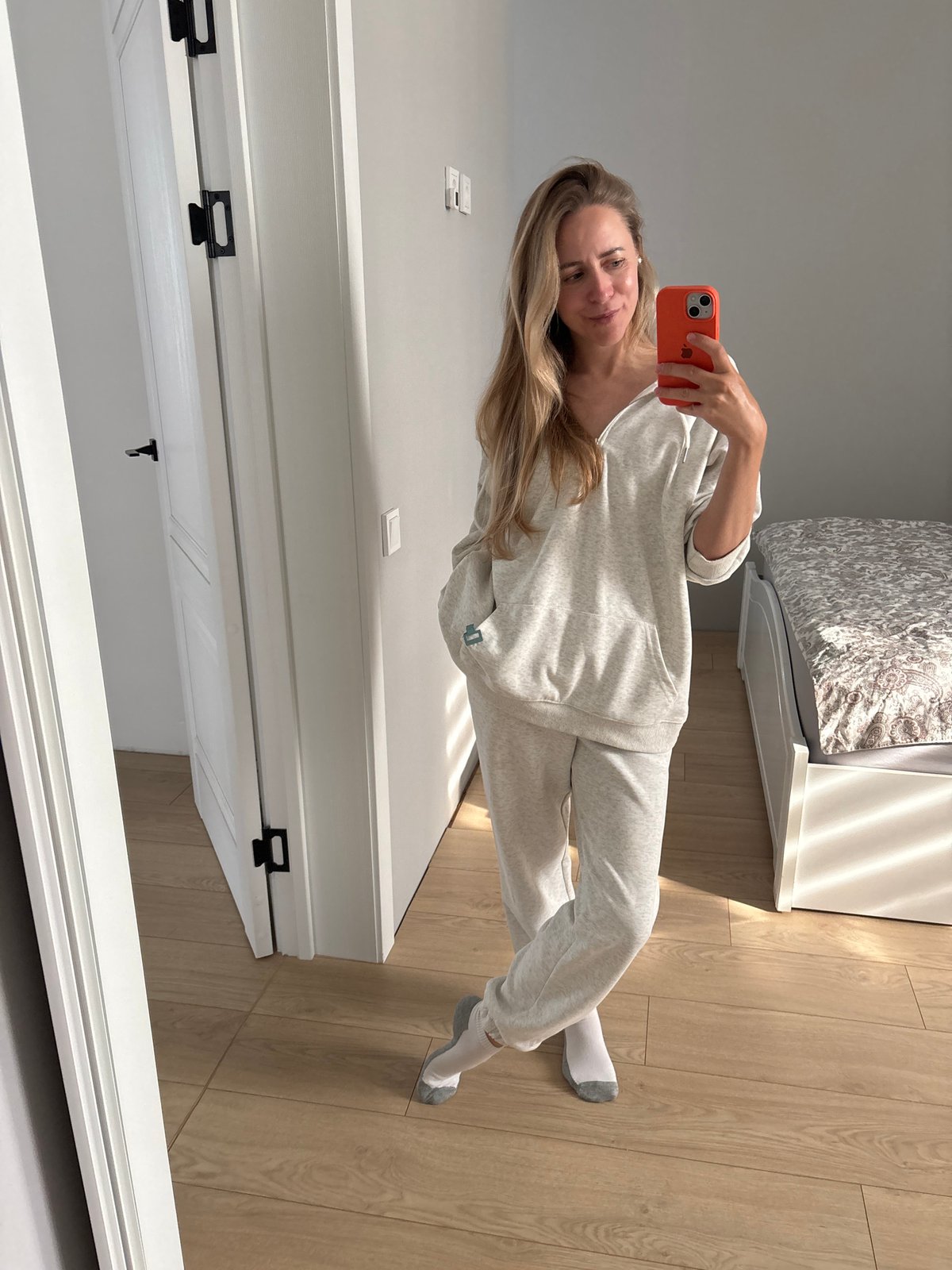 Quick selfie session at home in Chaikovsky, gray hoodie and orange phone