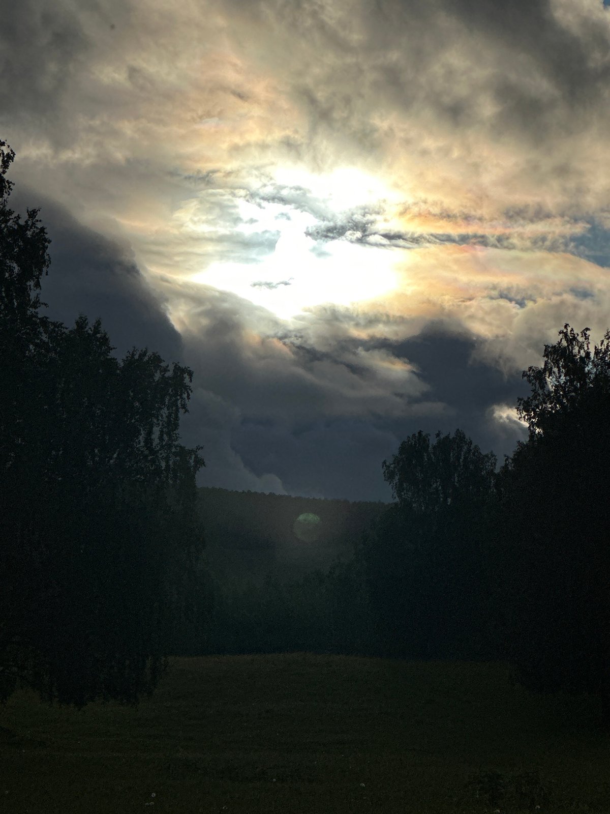 Woman documents countryside nature walk amid dramatic skies