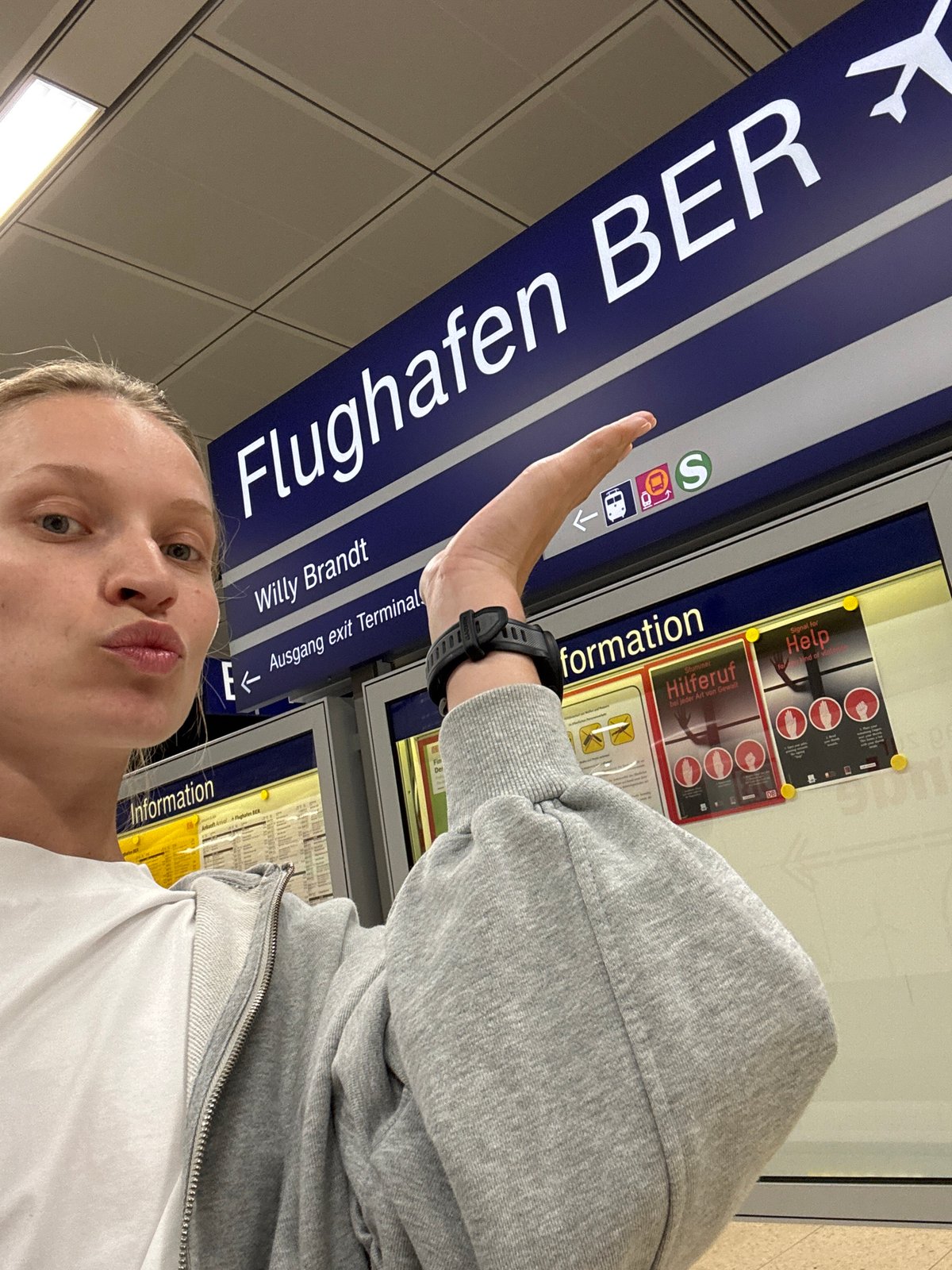 Woman documents visit to Berlin Brandenburg Airport terminal, platform