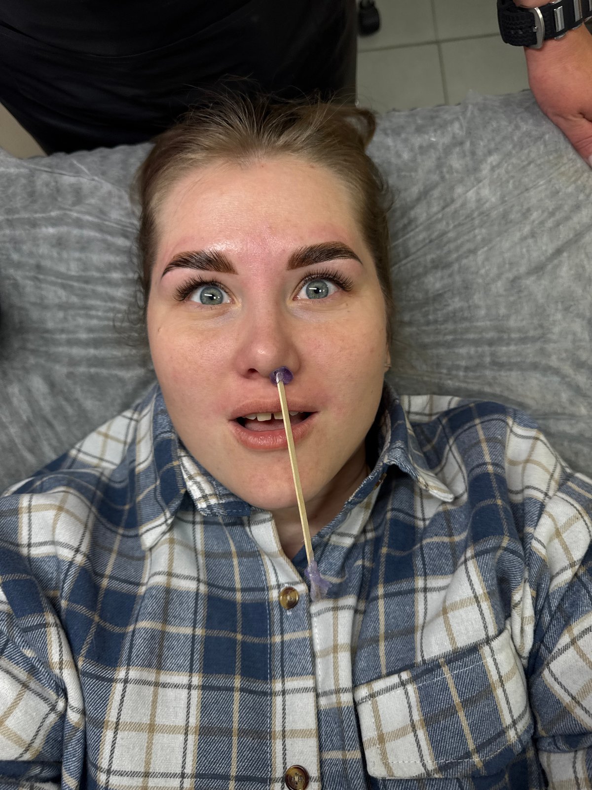 Woman receives eyebrow treatment at Perm beauty salon