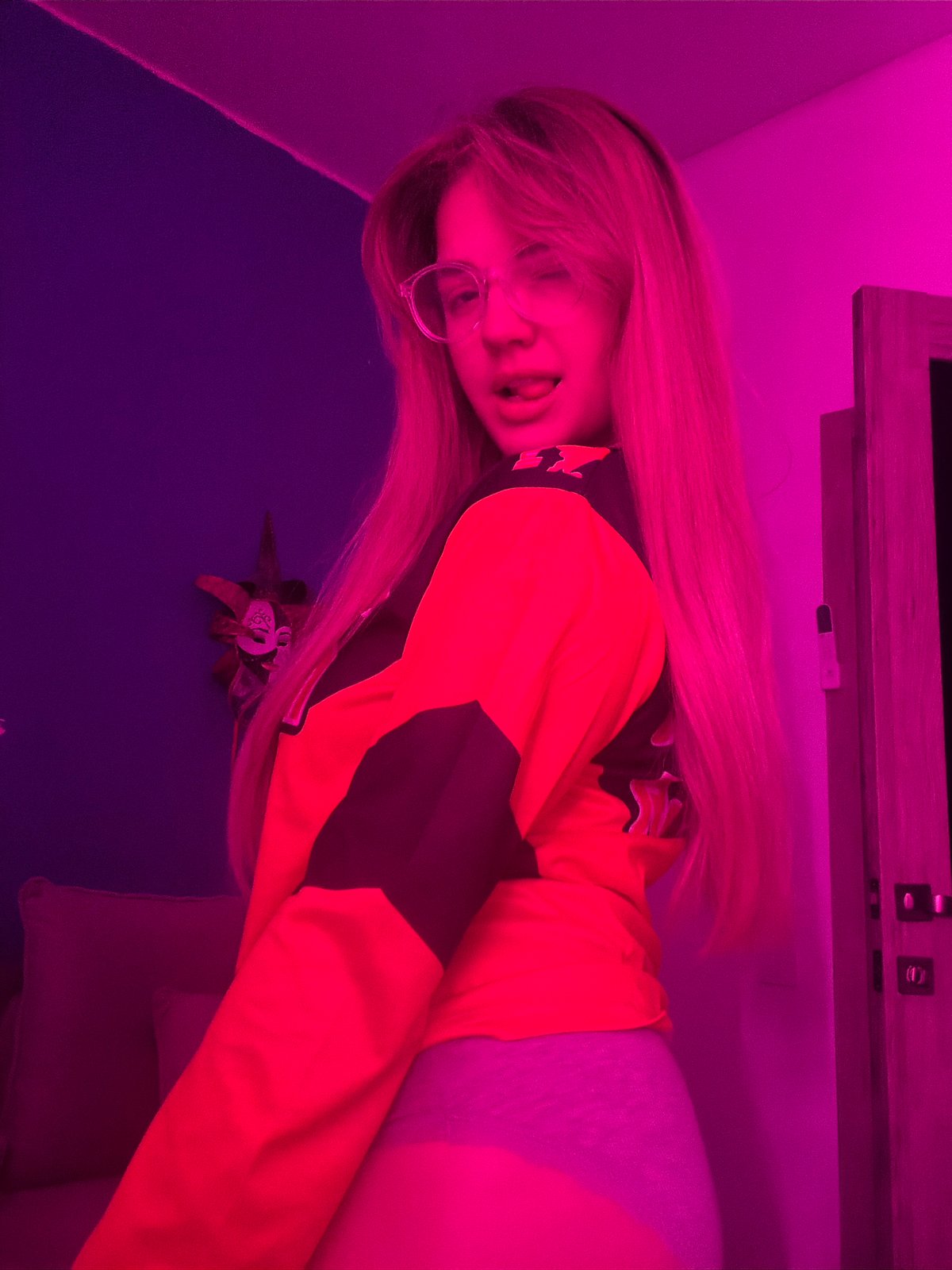 Woman photographed in colorful lighting at Russian residence