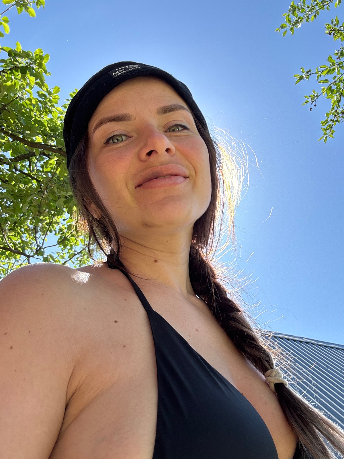 Woman and dogs spend morning moments in Rusalevka backyard