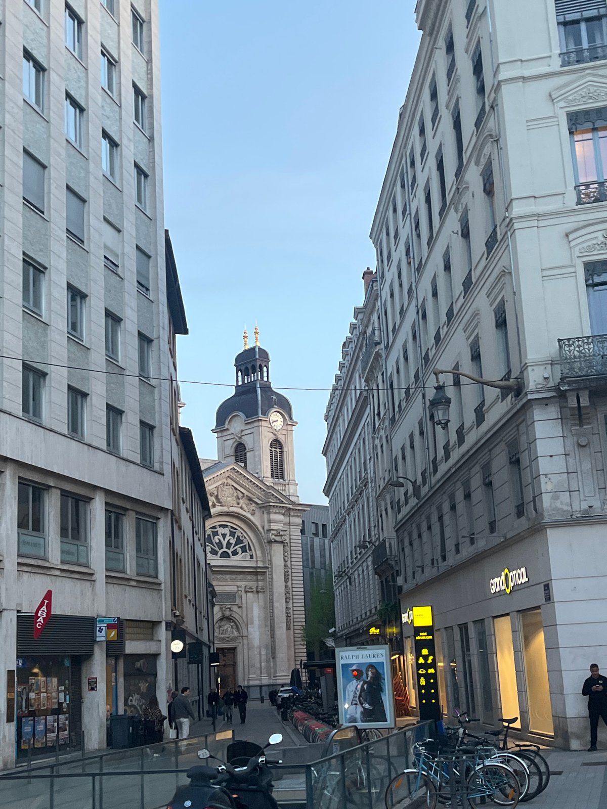 Street view captured in Lyon showing buildings, distant church tower