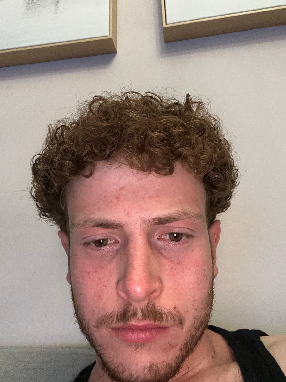 Man rests on couch in New York apartment