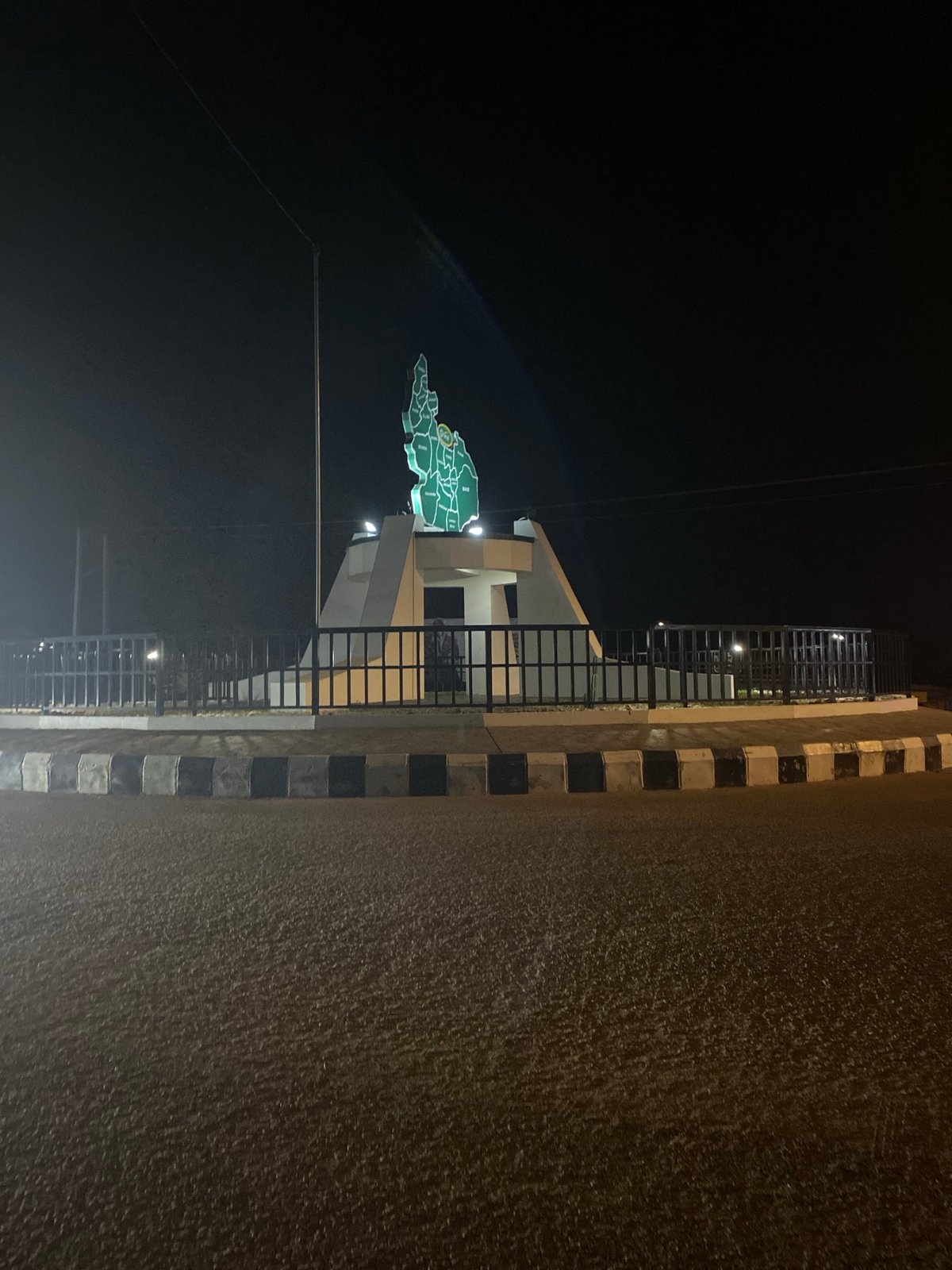 Illuminated Nigeria map monument photographed at night in Bukuru
