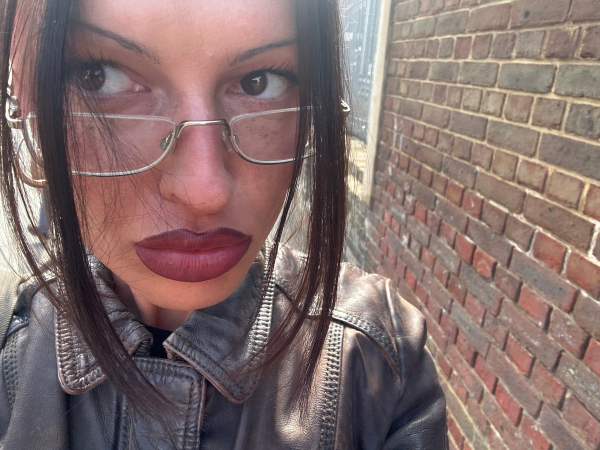 Upside-down selfie captured against brick wall in Tonbridge area