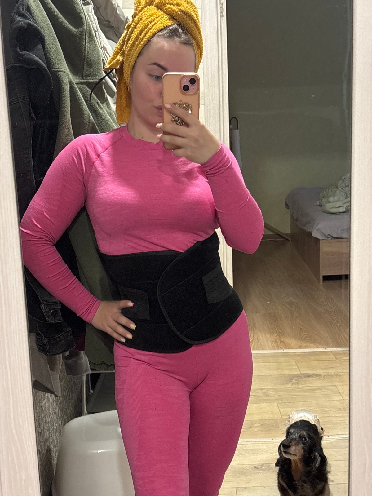 Person takes mirror selfie in pink athletic wear, Izhevsk