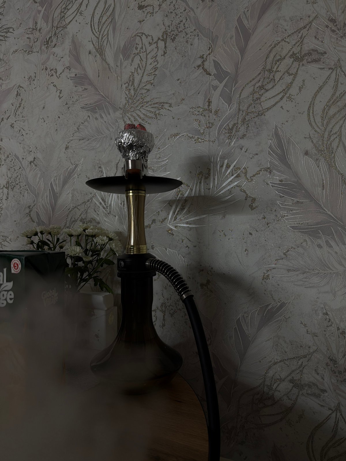 Woman enjoys quiet evening with food and hookah at home
