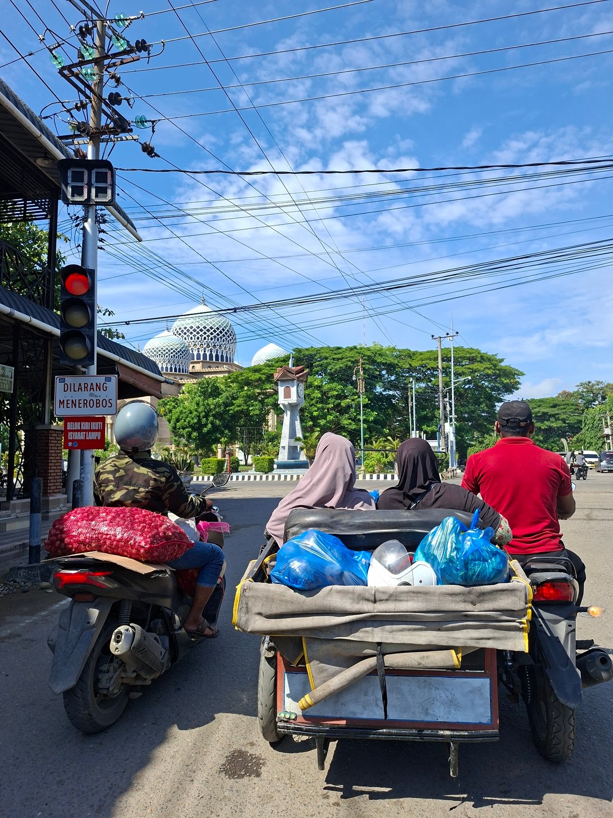 Daily life unfolds in Lhokseumawe: markets, cooking, transport, play