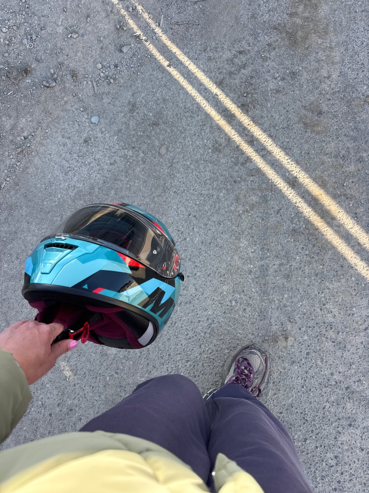 Person with motorcycle helmet observed on concrete surface in Sofia