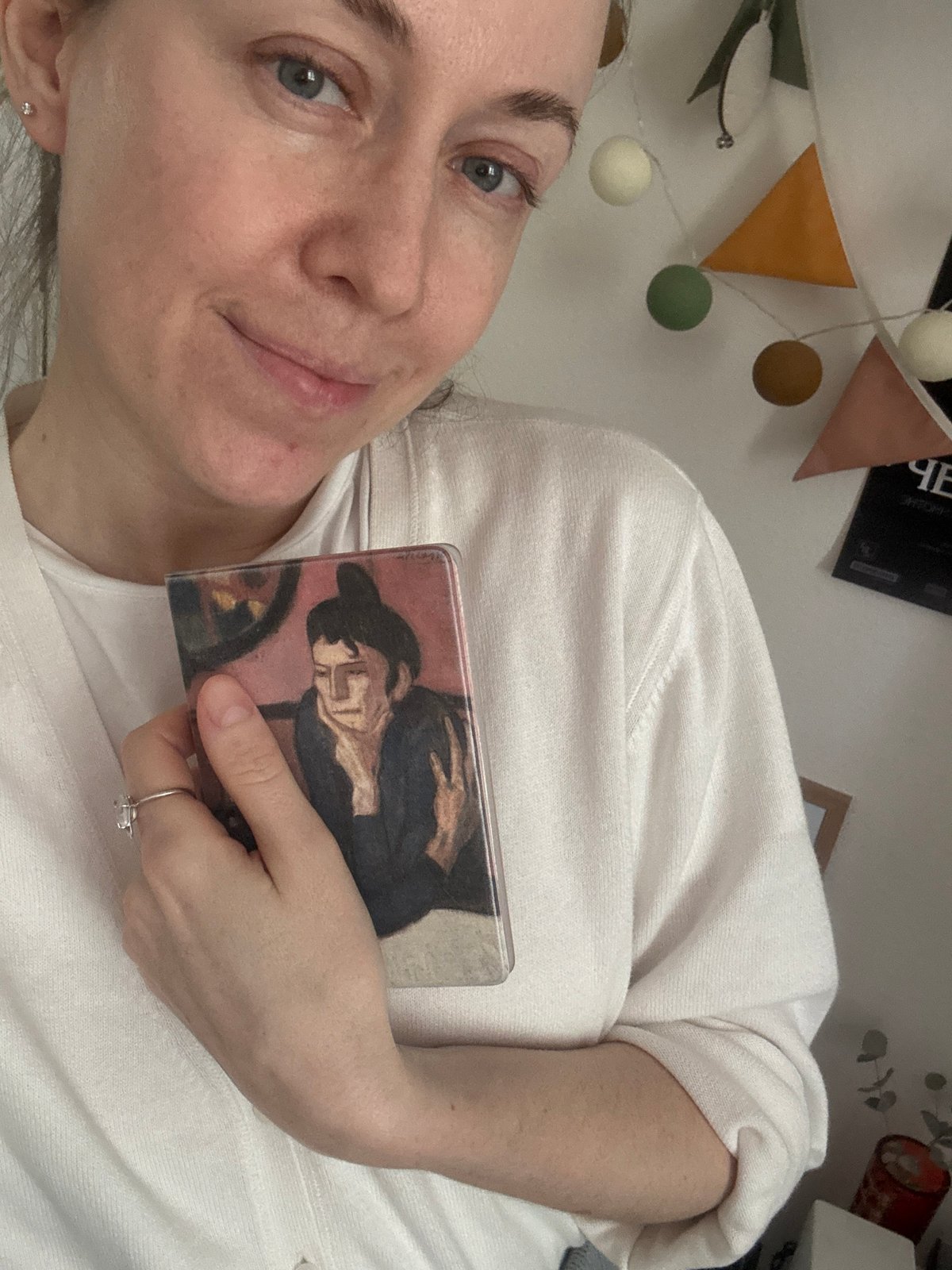 Woman photographs herself with books in Kudrovo home