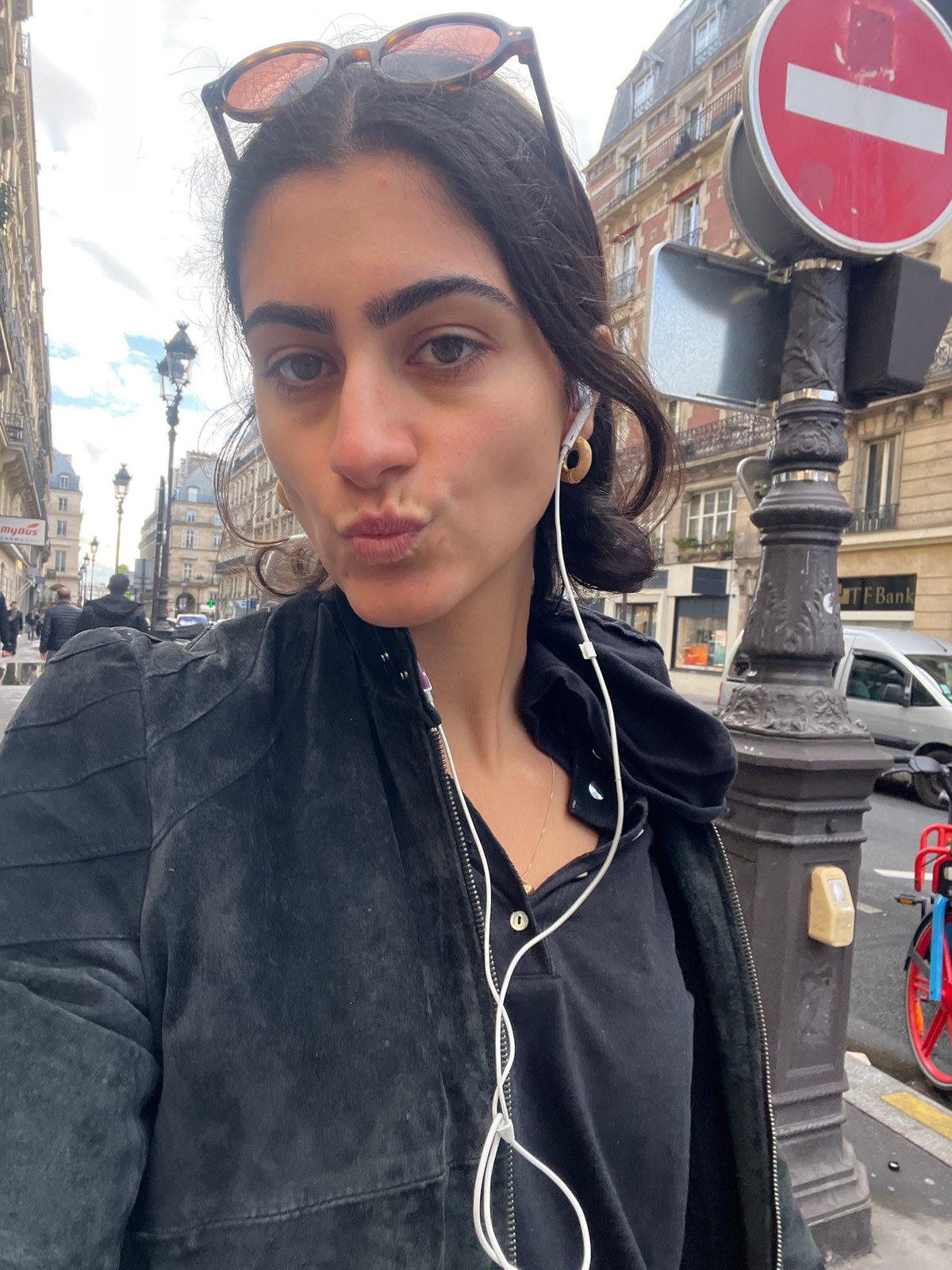 Woman takes selfie on Parisian street amid iconic architecture
